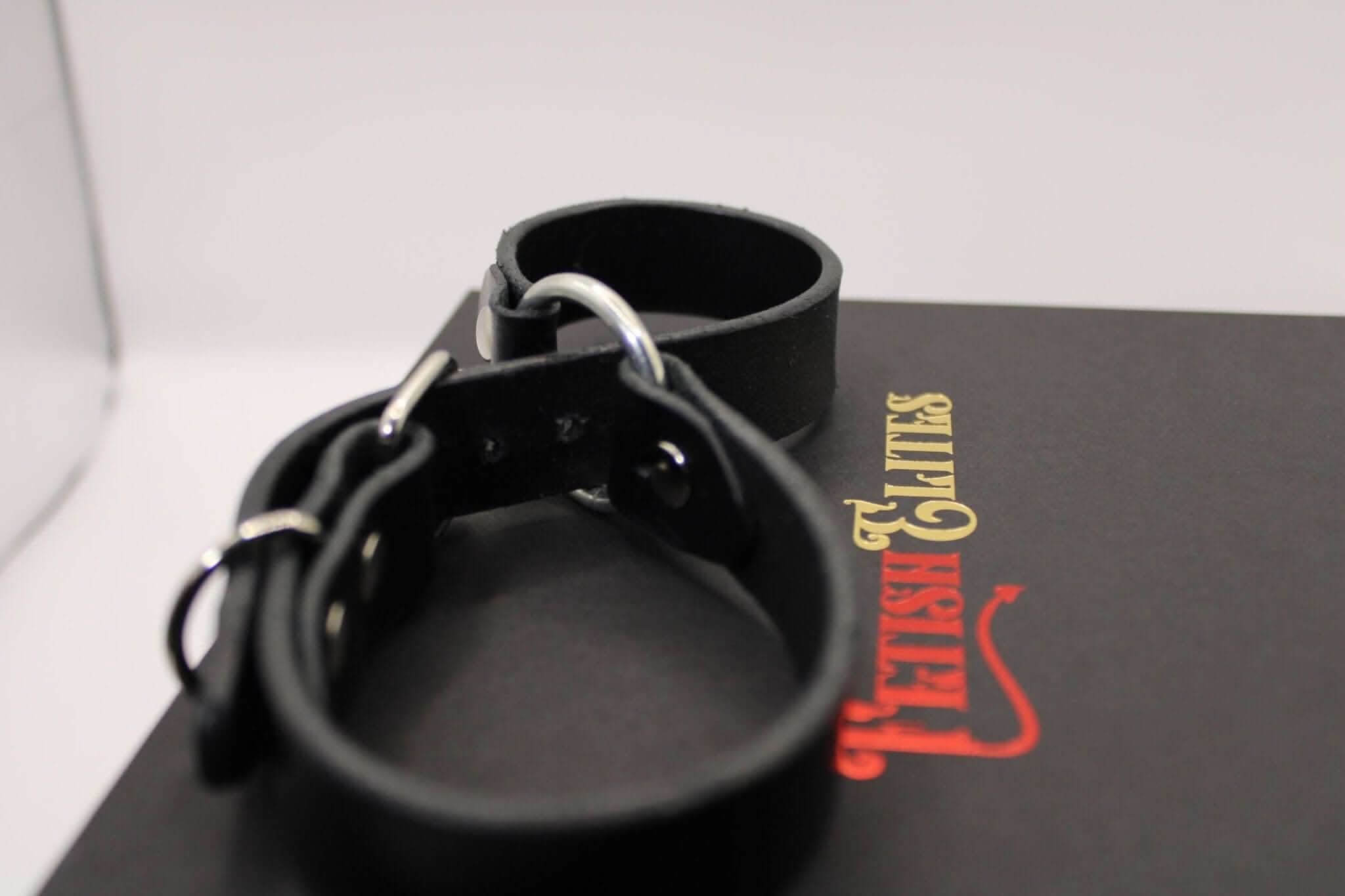 Leather handcuffs on a stylish box, perfect for BDSM enthusiasts and intimate couples exploring submission and bondage play.
