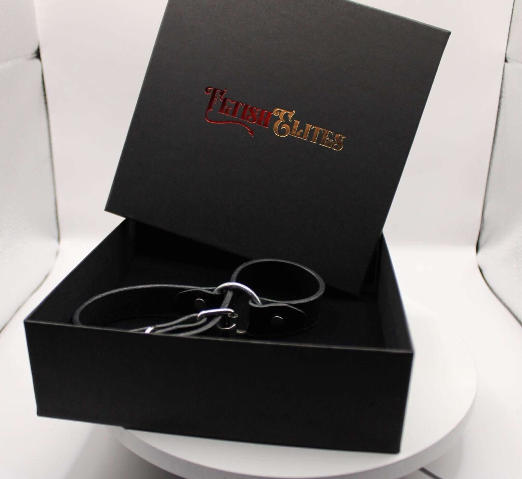 Leather handcuffs in elegant packaging, perfect for BDSM play and enhancing intimacy in dom-sub relationships.