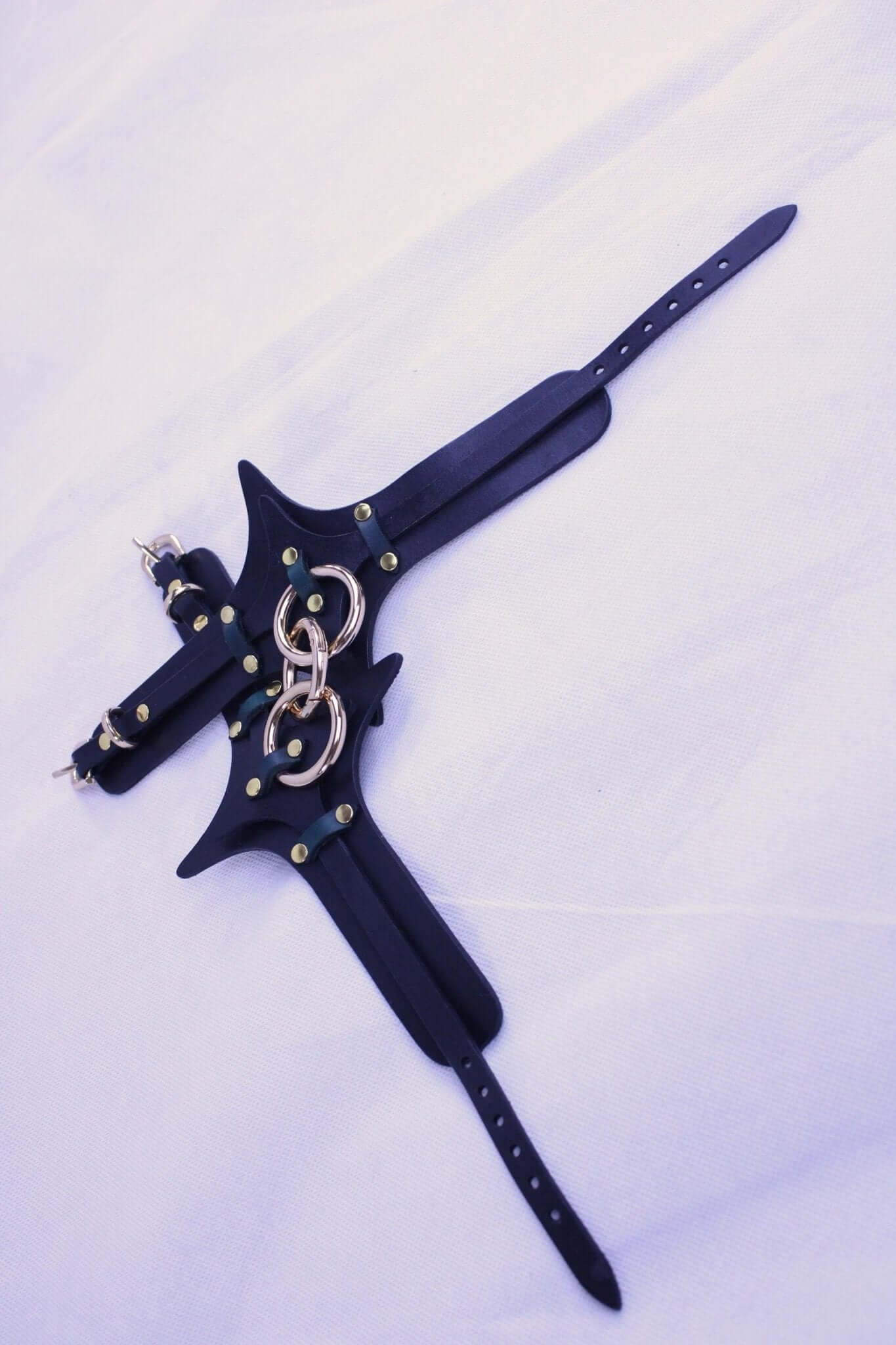 Premium leather bondage harness with adjustable straps and metal rings, perfect for BDSM and submissive play.