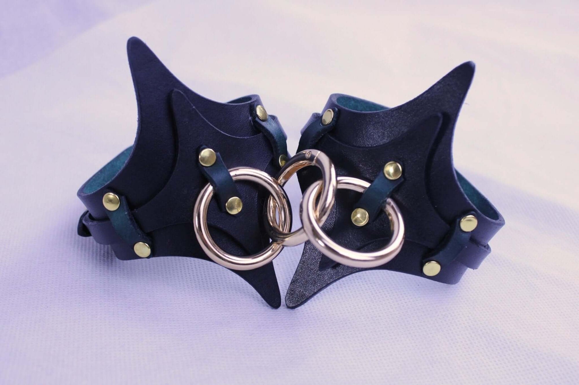 Premium leather handcuffs with metal rings, ideal for BDSM bondage gear and submissive experiences.