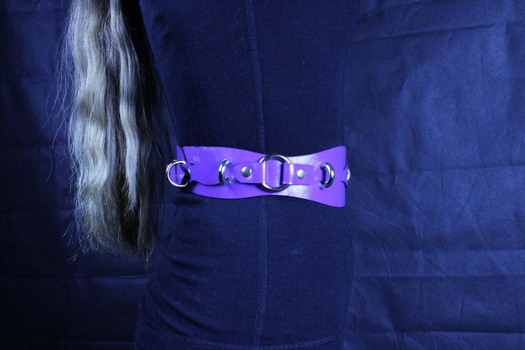 Purple leather restraint belt with D-rings, perfect for BDSM play and bondage gear accessory.