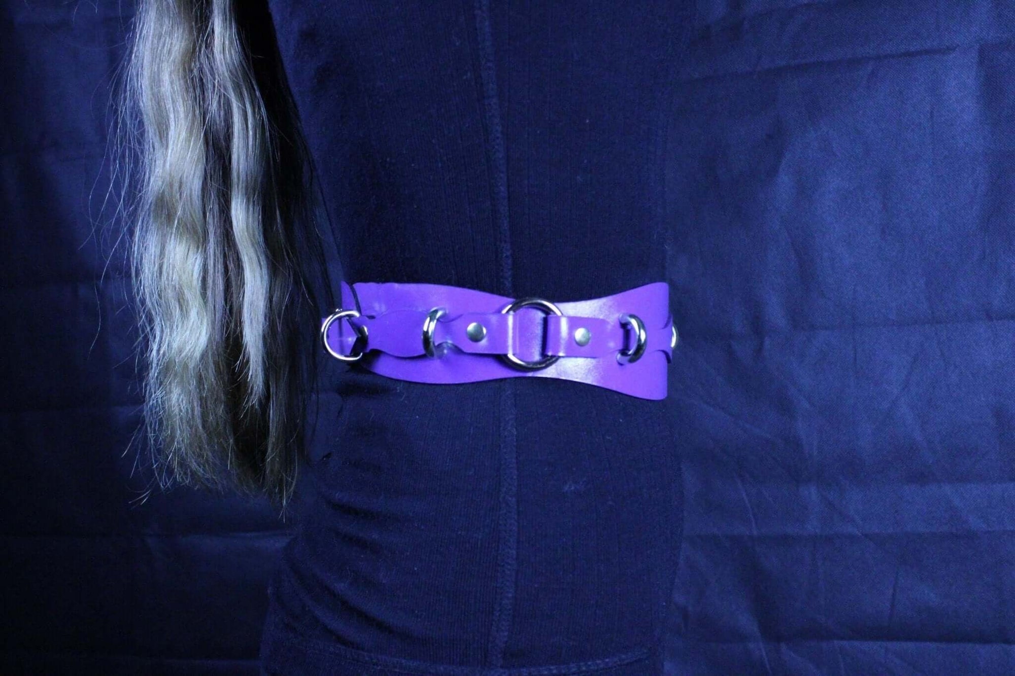 Purple leather restraint belt with D-rings, perfect for BDSM play and bondage gear accessory.