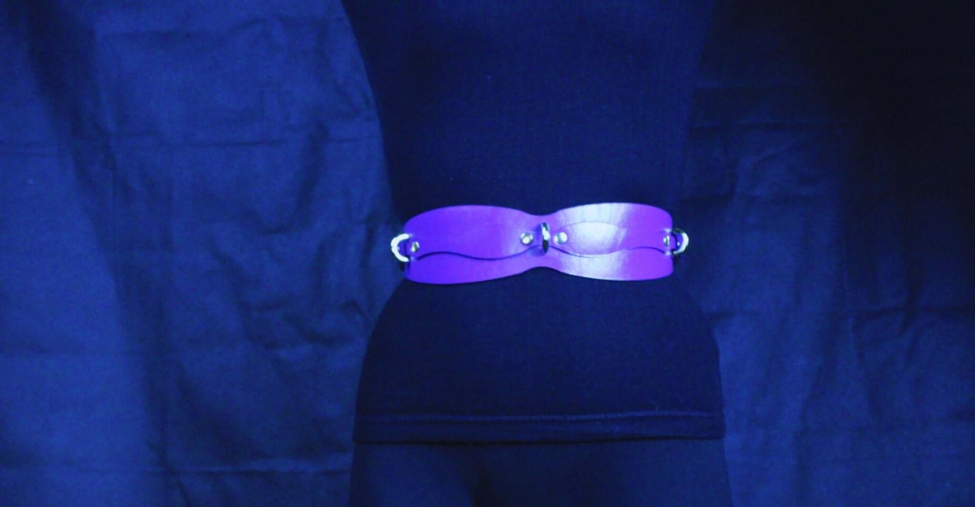 Handmade leather restraint belt in vibrant purple, featuring D-rings for bondage play and submission gear.