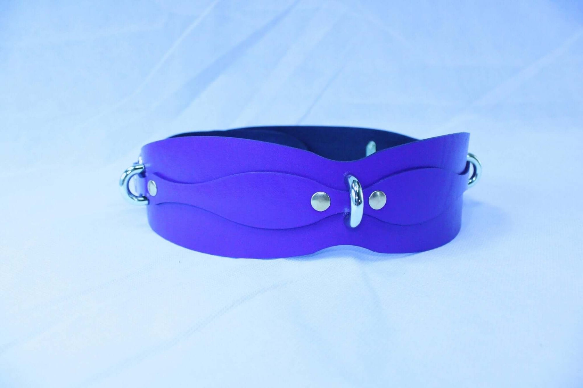Purple leather restraint belt with D-rings for BDSM play, perfect for submissive jewelry and bondage gear.