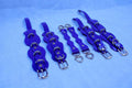 Purple leather bondage gear set with straps and rings for BDSM play, including cuffs and connectors for sub collar.