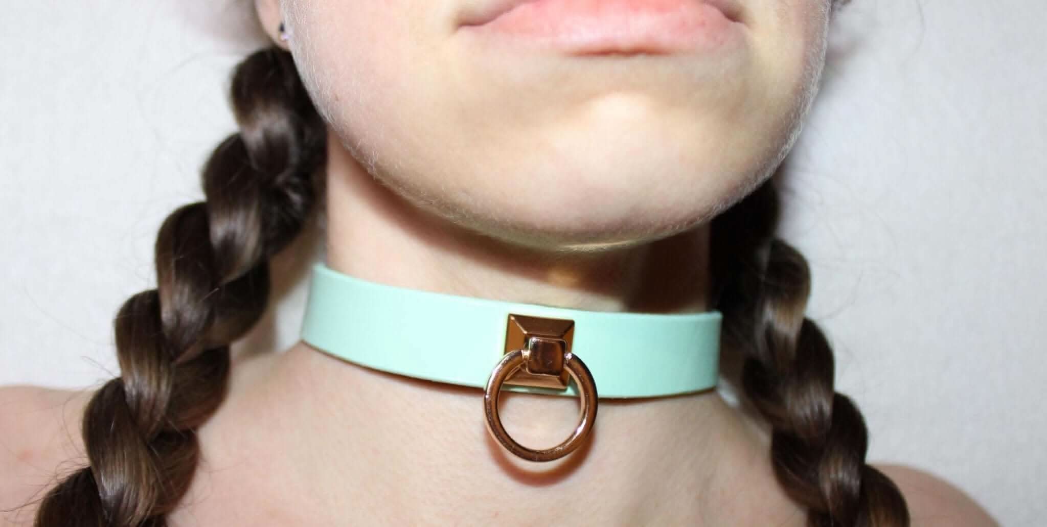 Mint green leather choker collar with O-ring, perfect for bondage and BDSM play as a submissive jewelry accessory.