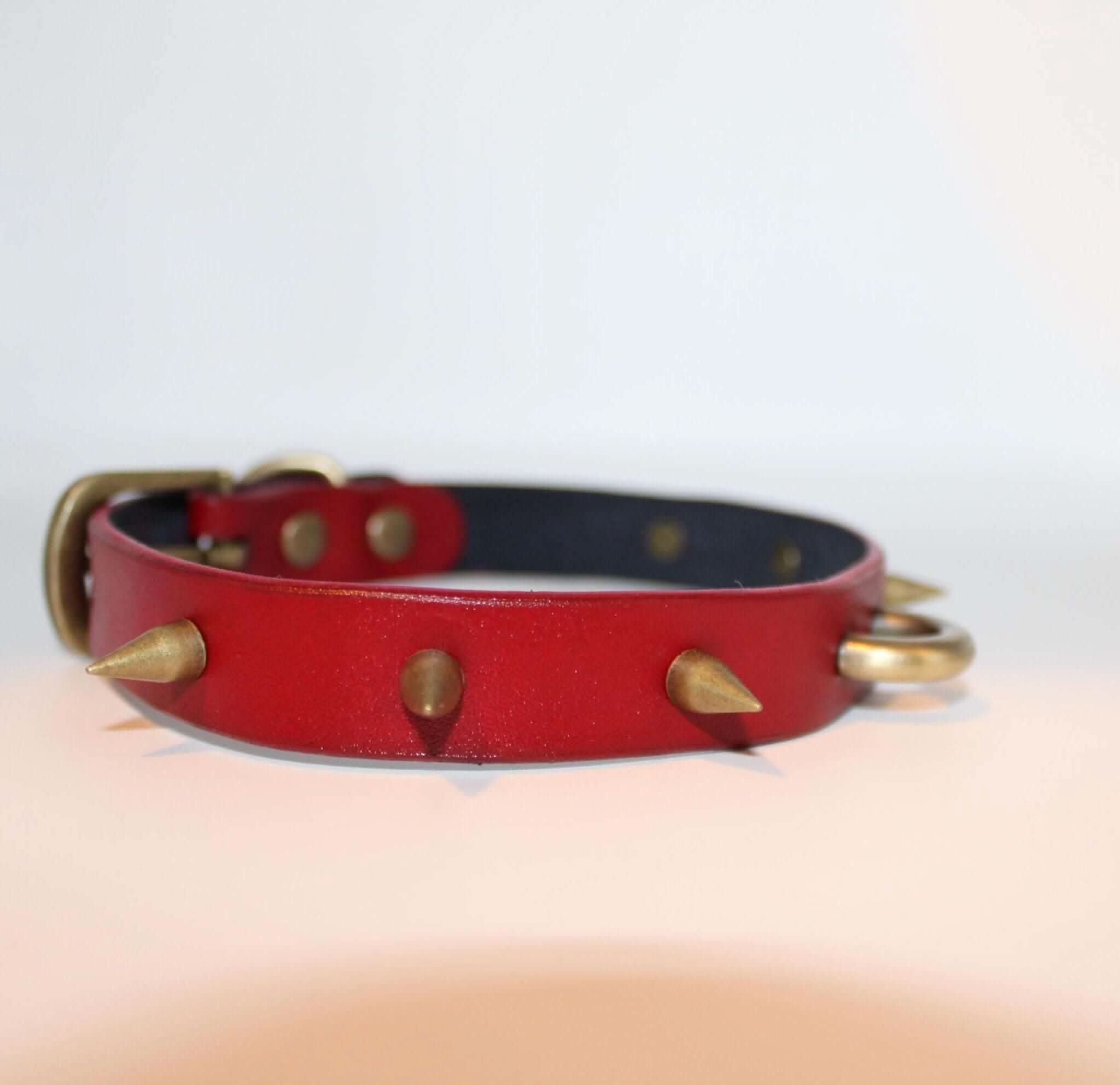 Red spiked BDSM collar with O-ring, perfect as a submissive accessory for kink and punk fashion.