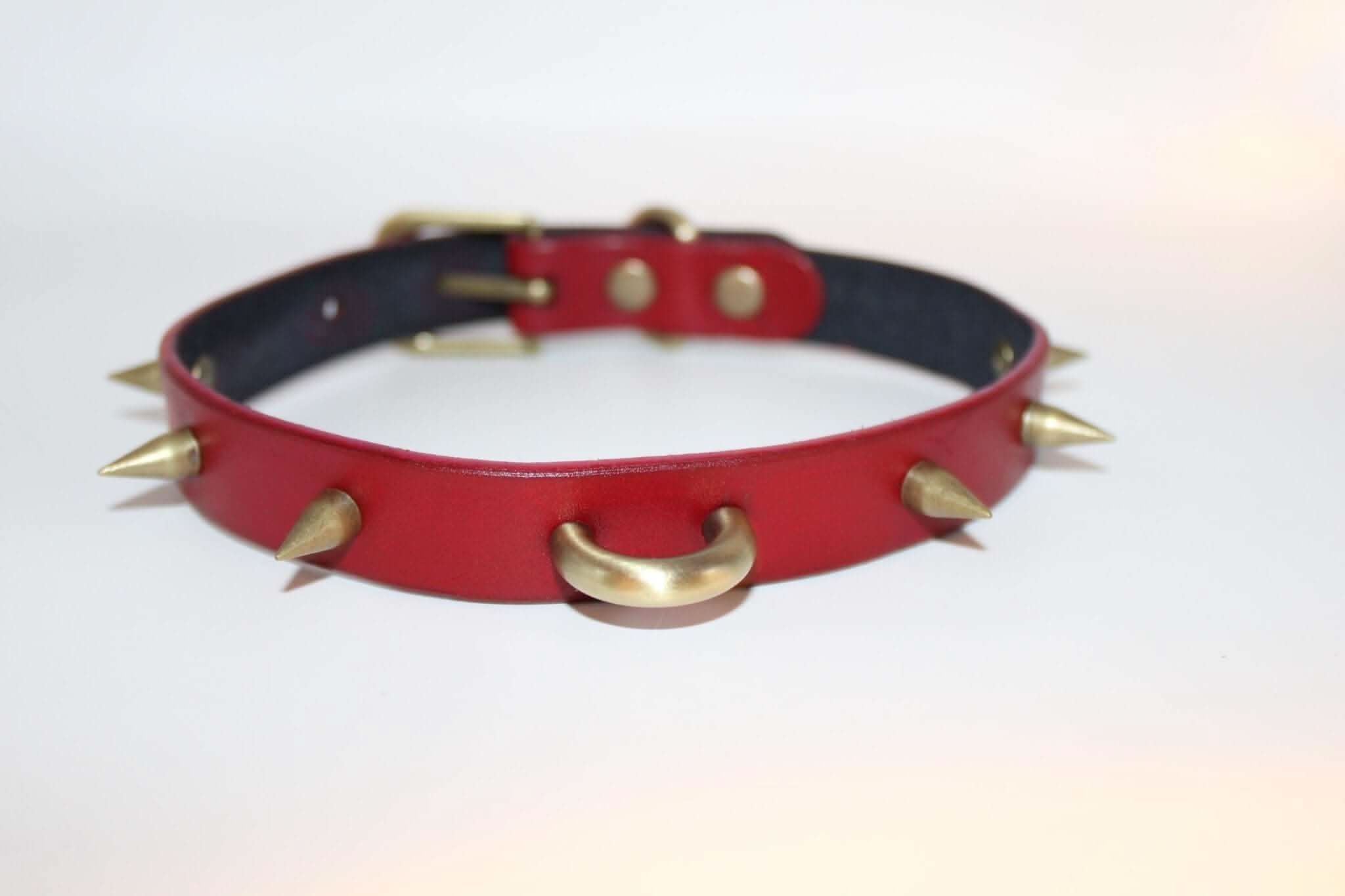 Spiked red BDSM collar with O-ring, perfect for punk fashion, submissive jewelry, and bondage gear.