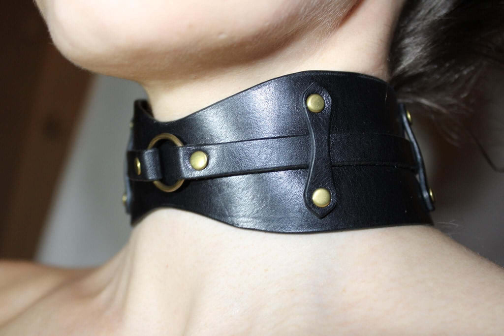 Black leather choker collar with gold hardware, ideal for BDSM, submissive jewelry, and edgy fashion.