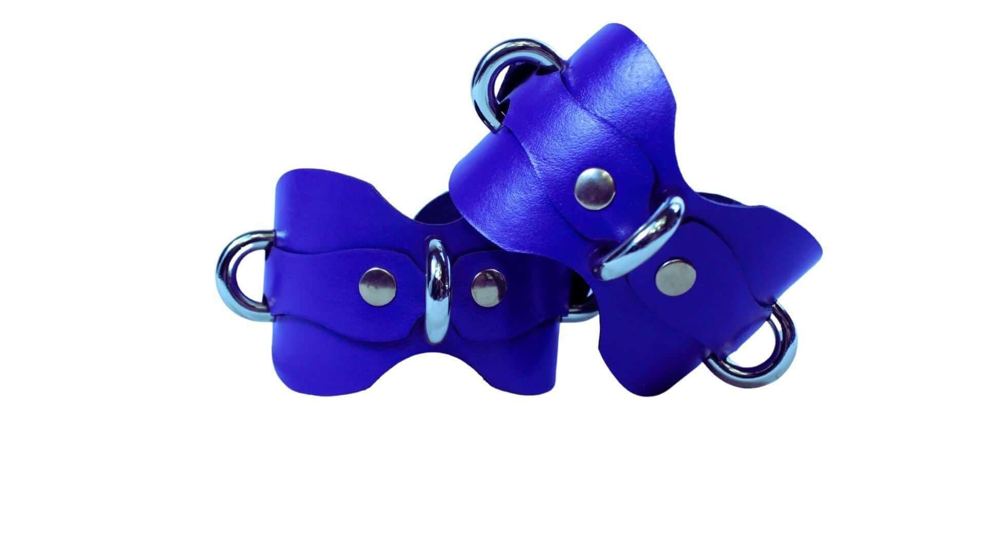 Handmade blue leather wrist cuffs with D-rings for BDSM, bondage play, and submissive roleplay accessories.