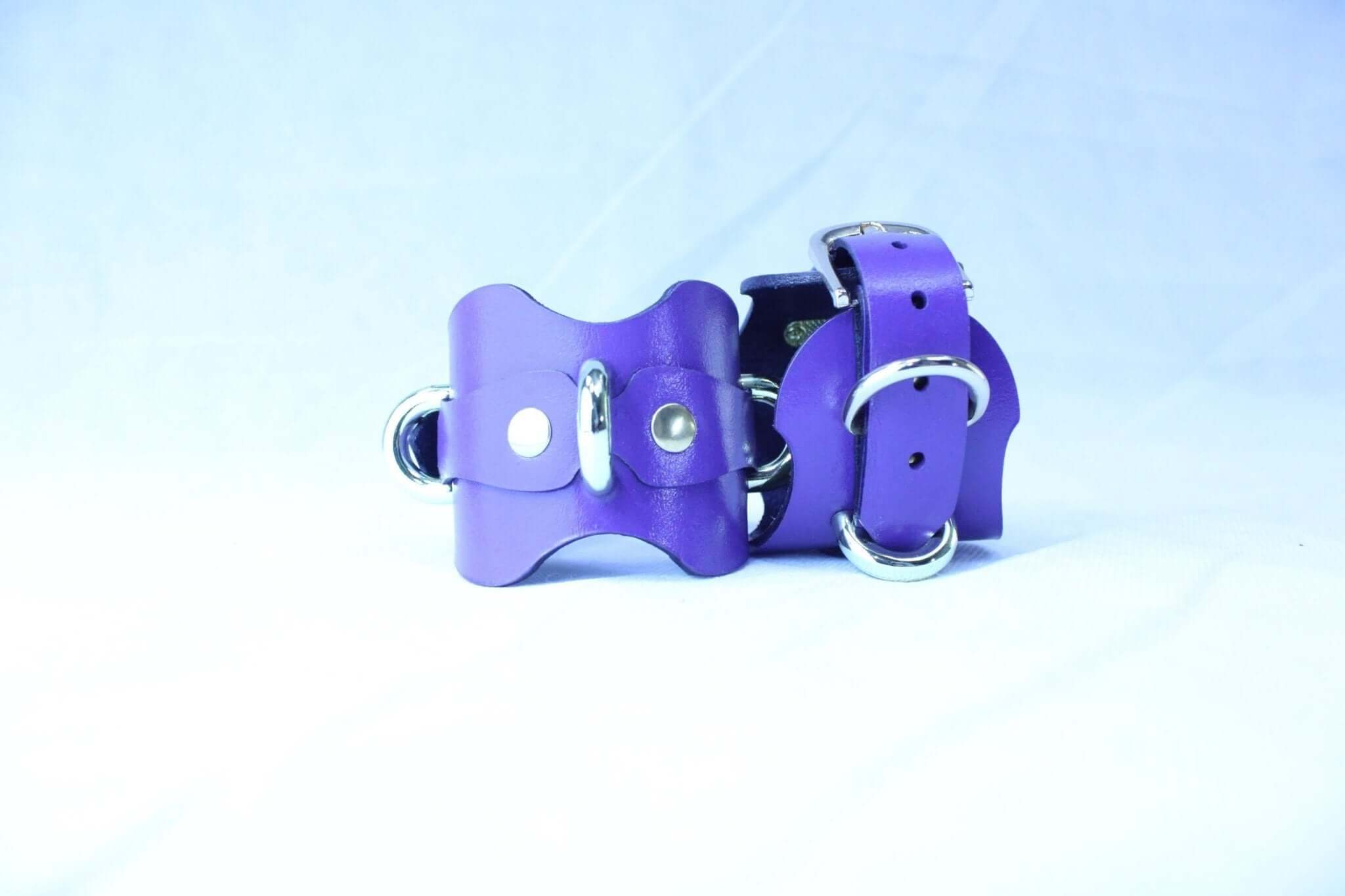 Purple handmade leather wrist cuffs with D-rings for BDSM, bondage gear, and roleplay.