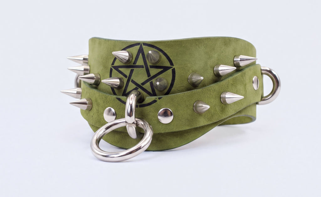 A green leather choker necklace with silver spikes and a star-shaped emblem.