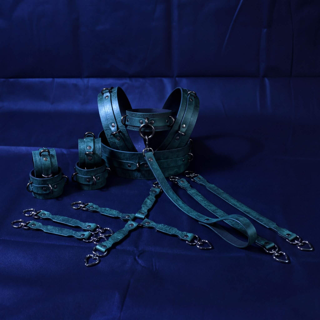 A collection of dark green leather straps and buckles arranged on a blue background.