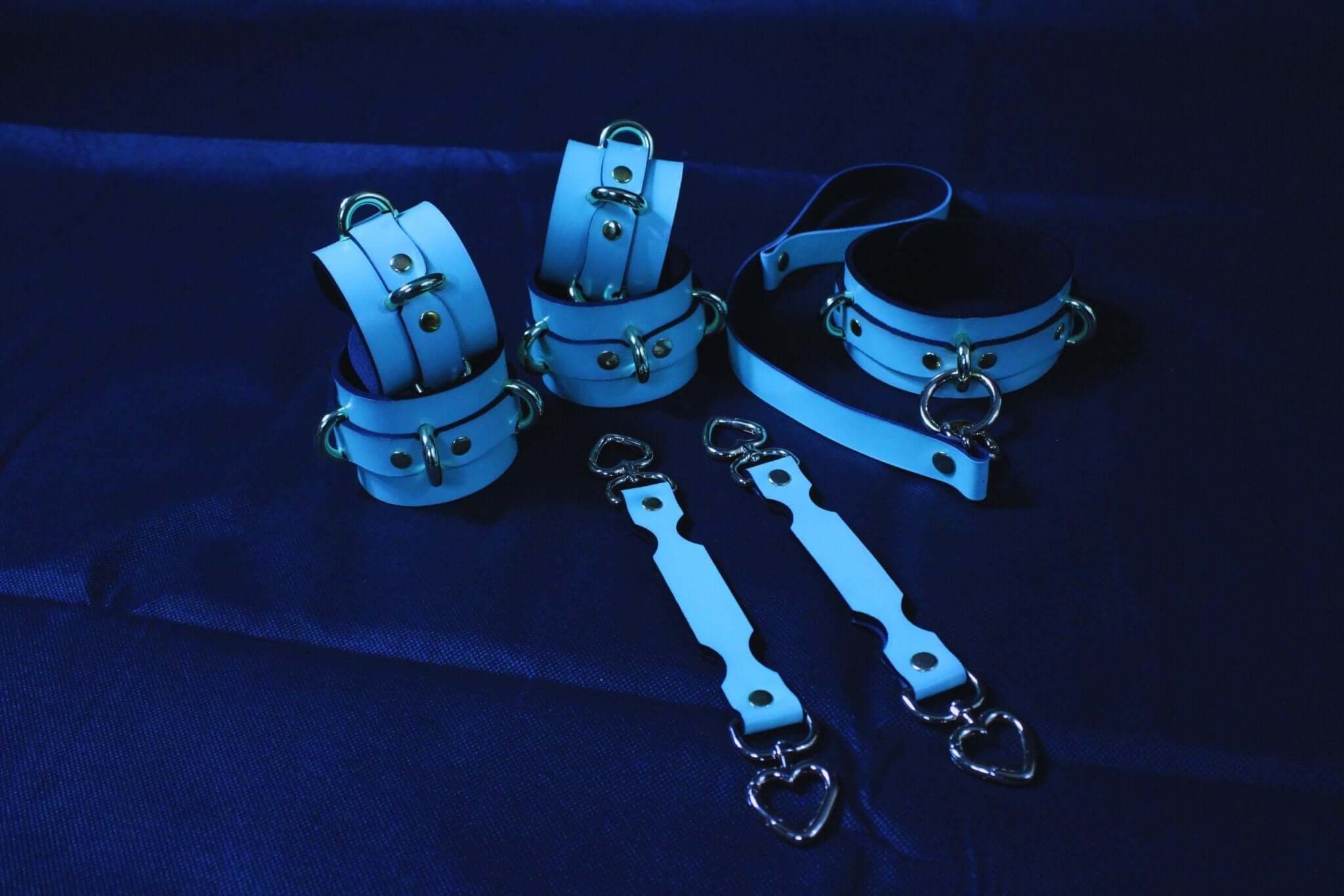 Blue BDSM bondage gear set featuring cuffs and connectors for submissive play and erotic exploration.