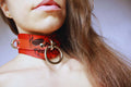 Bold skull leather collar worn as a statement BDSM accessory, perfect for submissive jewelry and adult bondage gear.