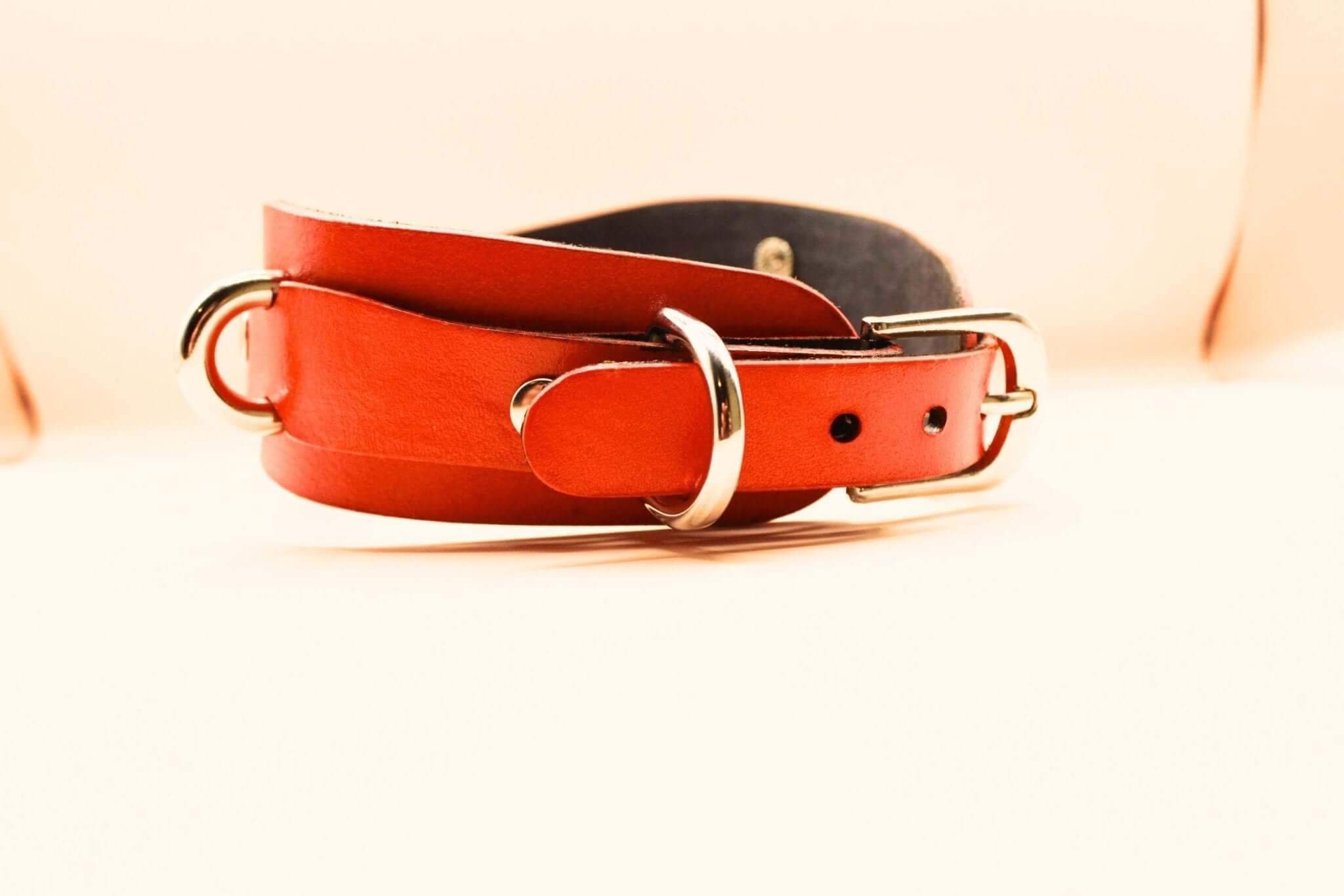 Bold red leather BDSM collar with silver hardware, ideal for submissive jewelry and bondage gear.