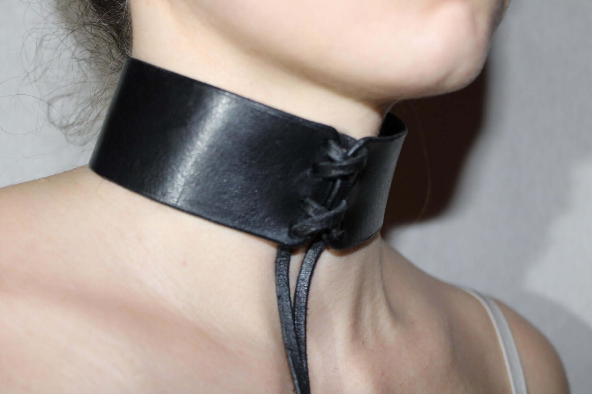 Sleek black leather BDSM collar, perfect for submissive jewelry and discreet day wear in bondage fashion.