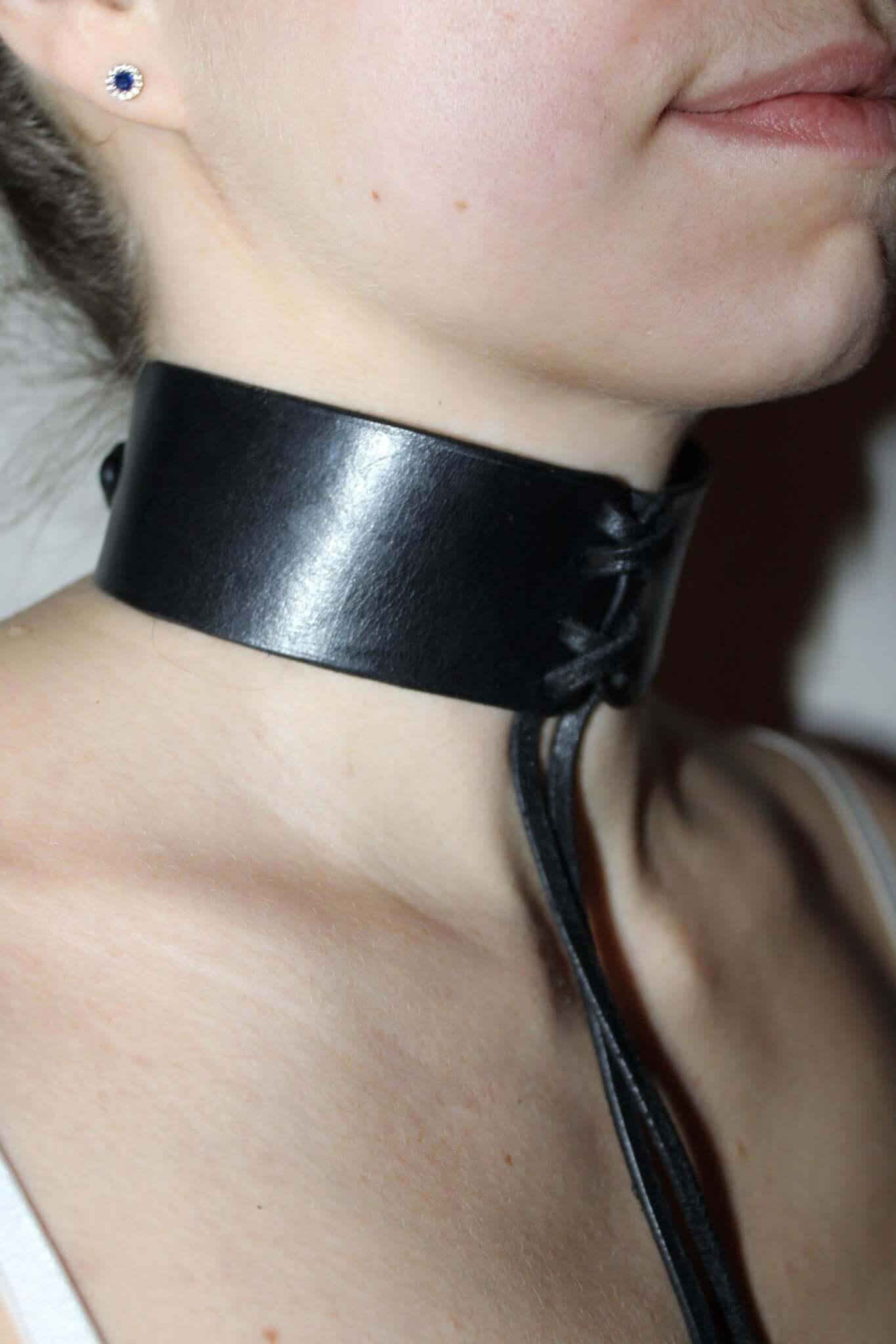 Sleek black leather bondage choker collar, perfect for BDSM roleplay and elegant submissive attire.