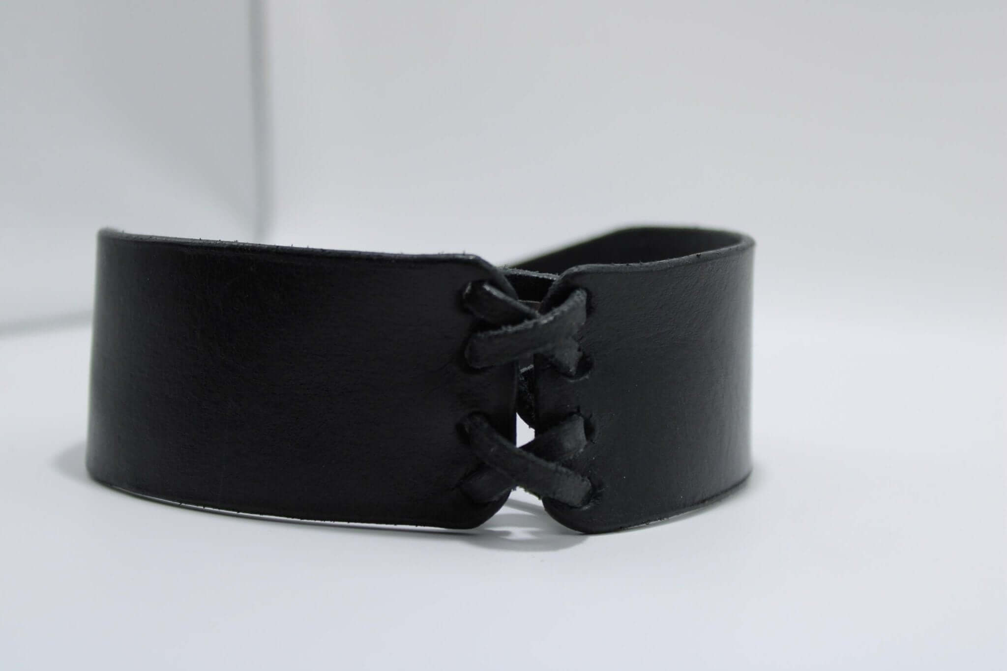 Bondage choker made of soft black leather, featuring lace-up design for BDSM roleplay and intimate settings.