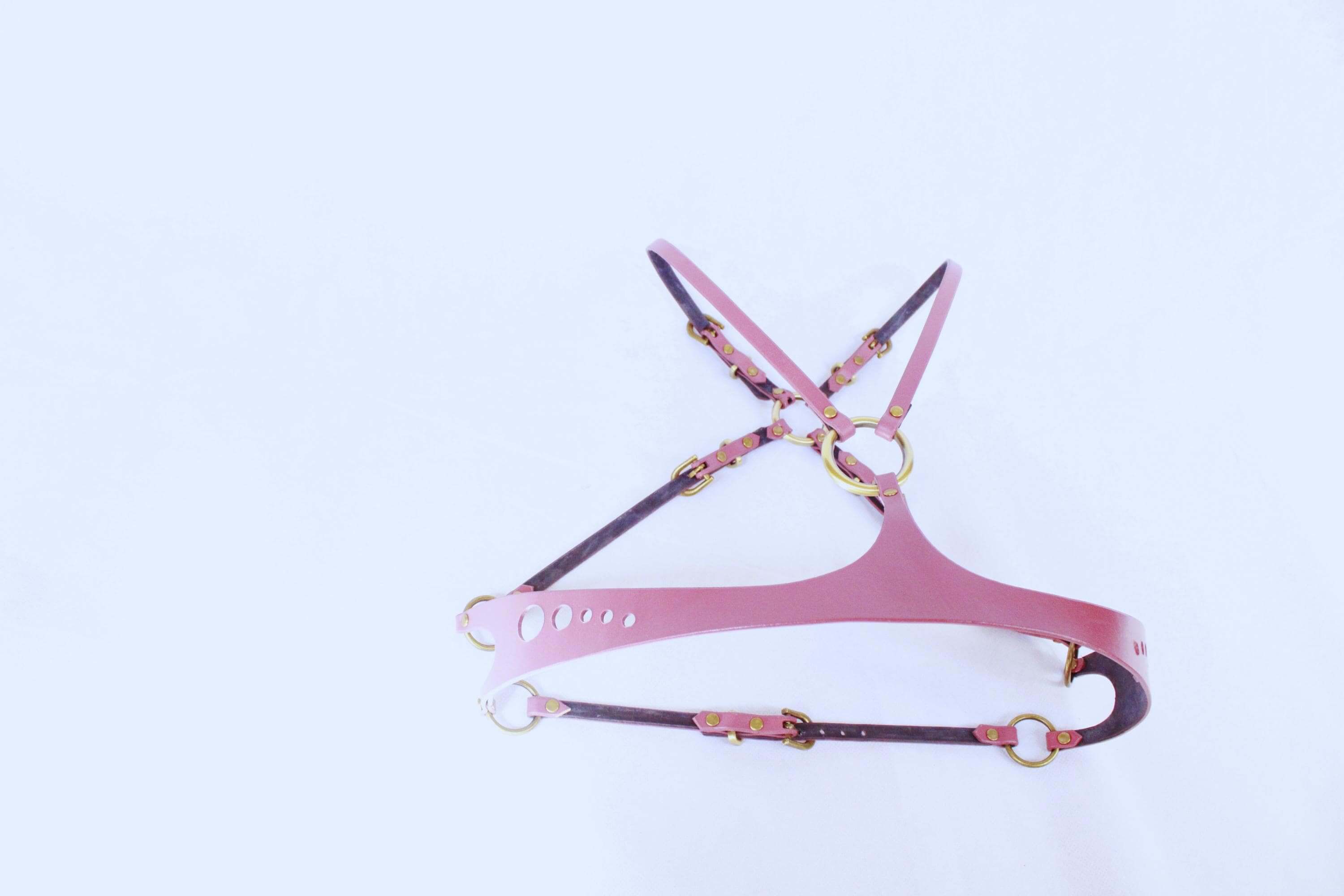 Pink leather bondage harness with gold accents, perfect for BDSM, body harness, and erotic lingerie.
