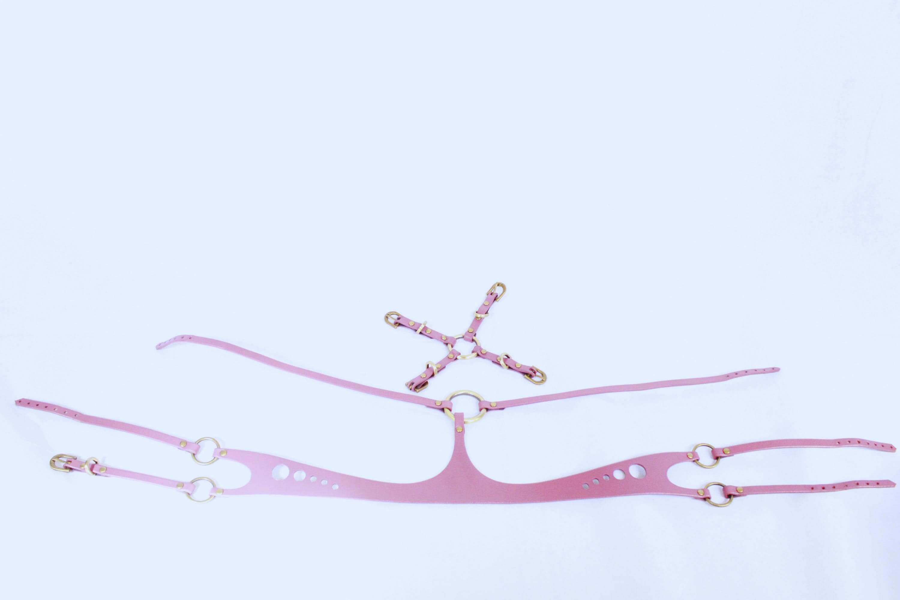 Pink leather underbust bondage harness with structured design for enhancing curves, ideal for BDSM and erotic lingerie.
