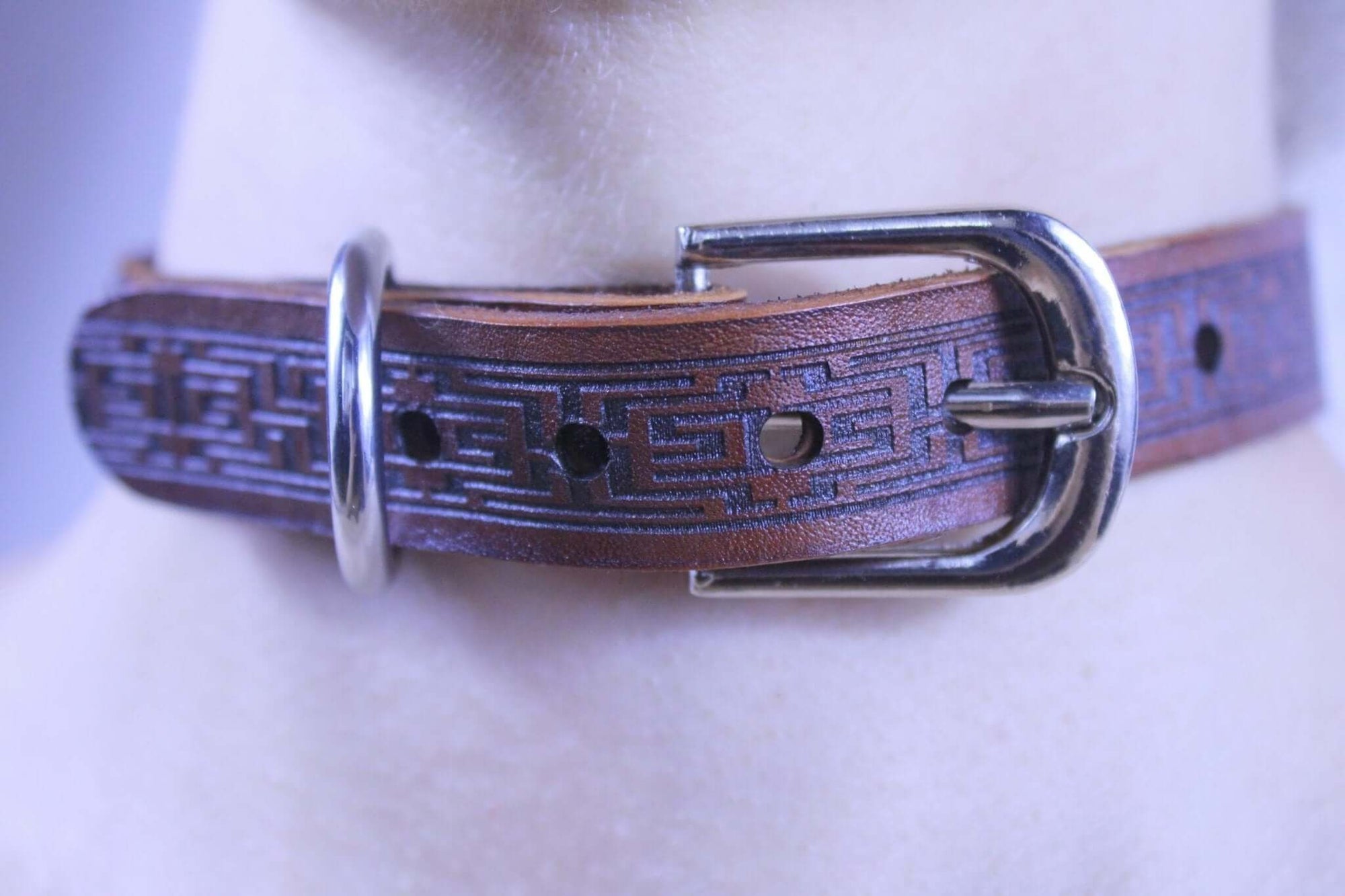 Brown leather submissive collar with intricate design, perfect for BDSM jewelry and discreet daywear.