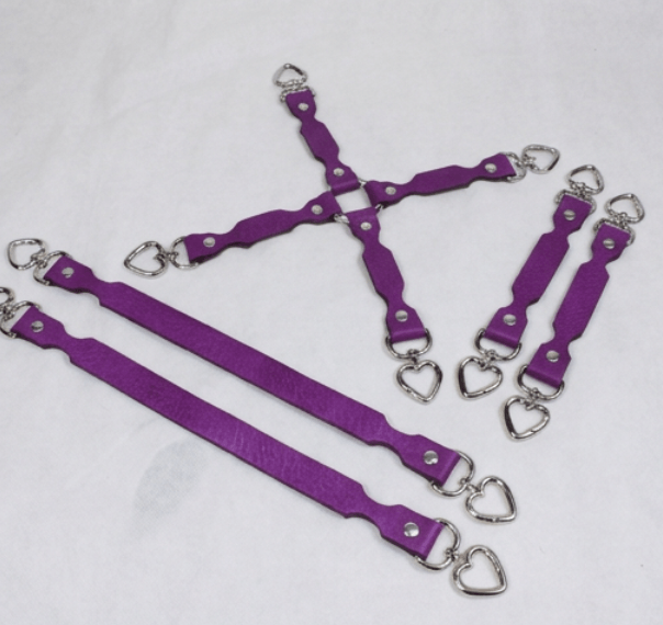 a collection of purple leather straps with metal heart-shaped buckles, arranged in various orientations on a white background.