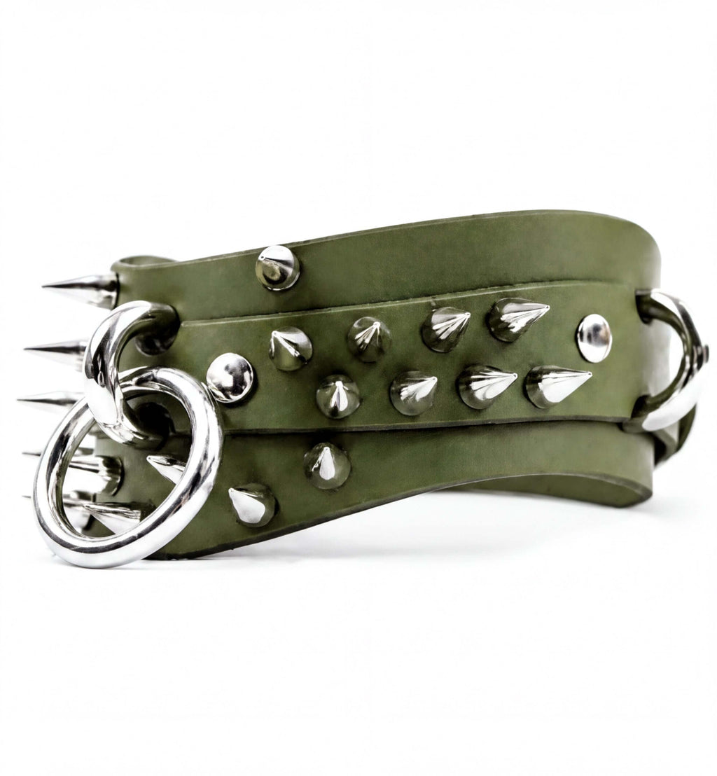 A green leather belt with silver spikes protruding from it.
