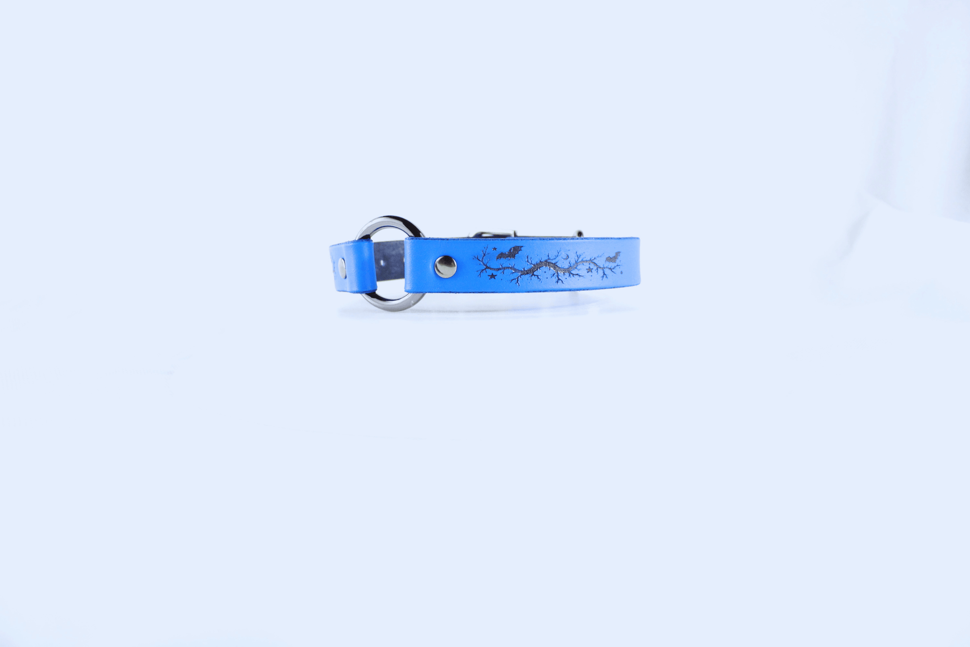 Submissive Collar Blue Moon & Bats Leather Choker in blue with detailed design, showcasing elegance and mystery.