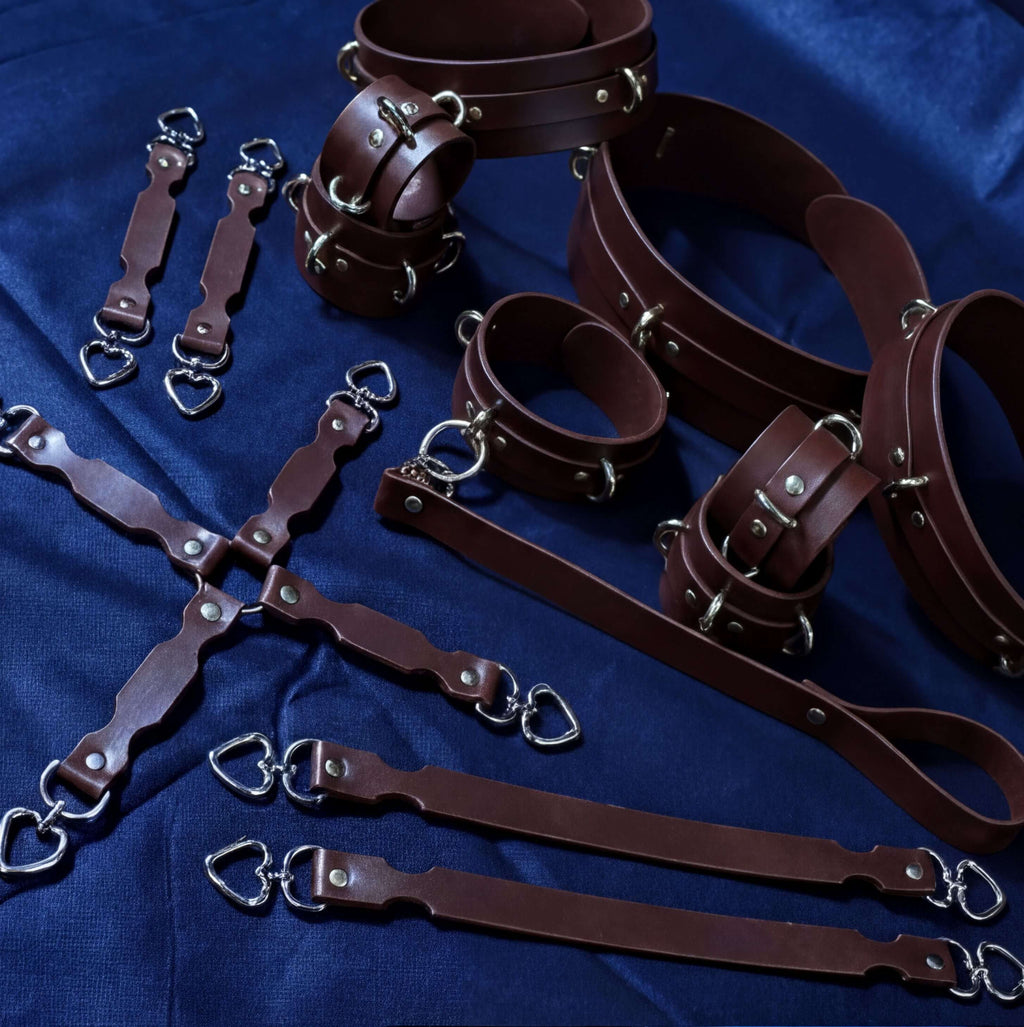 a collection of leather straps and buckles arranged on a blue background.