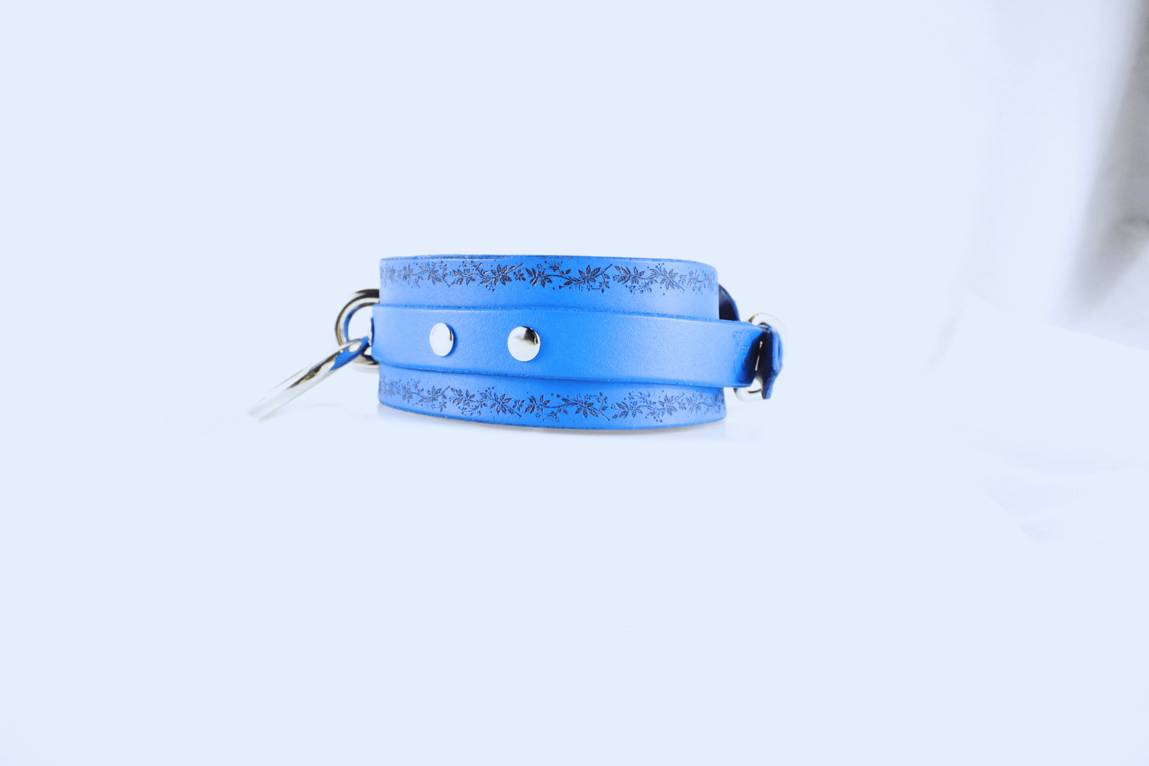 Floral Vine Leather Choker Discreet Sub Collar with O-Ring shown from the side, featuring a blue color with floral motifs.