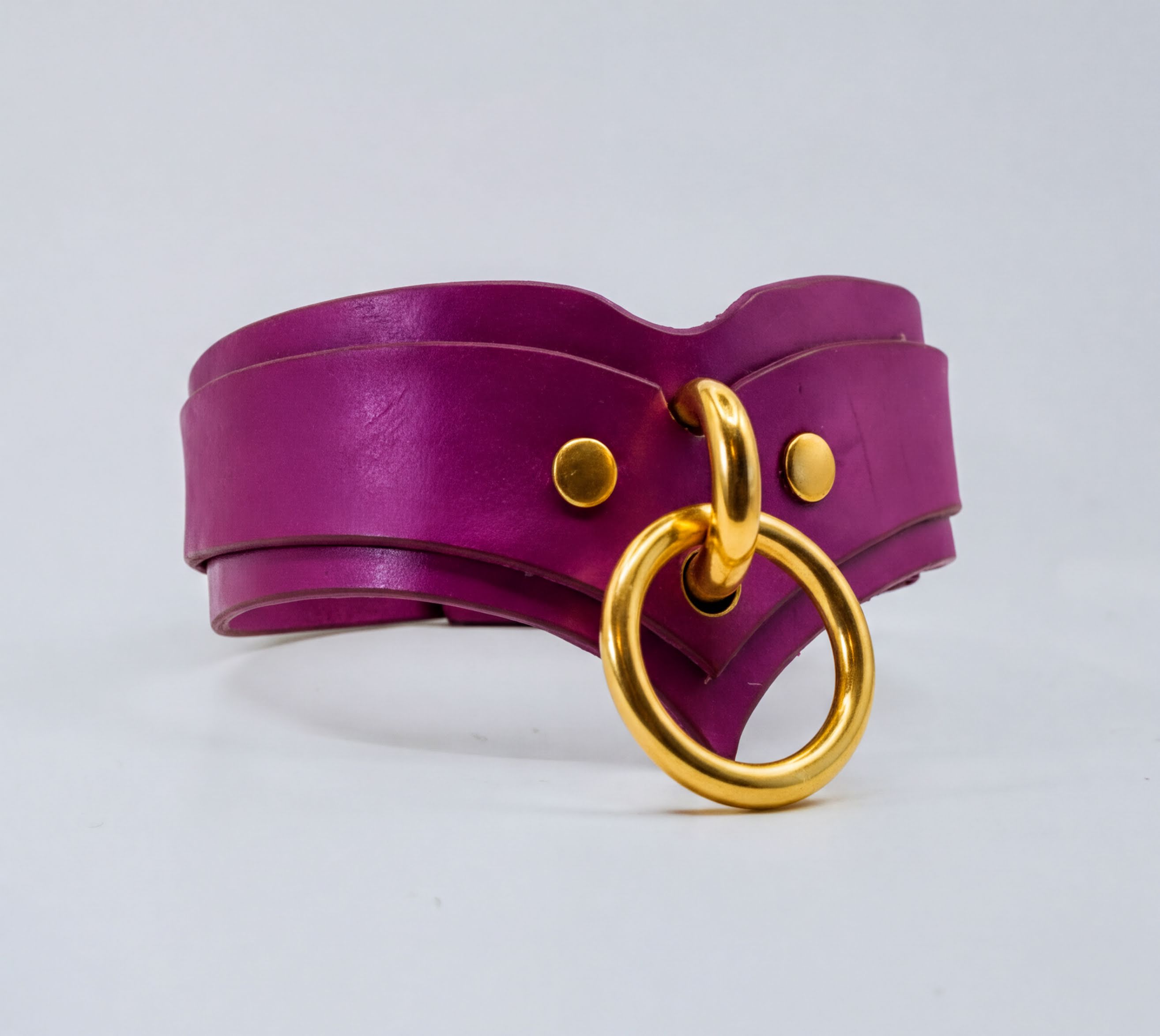 A purple leather choker necklace with a gold ring and buckle.