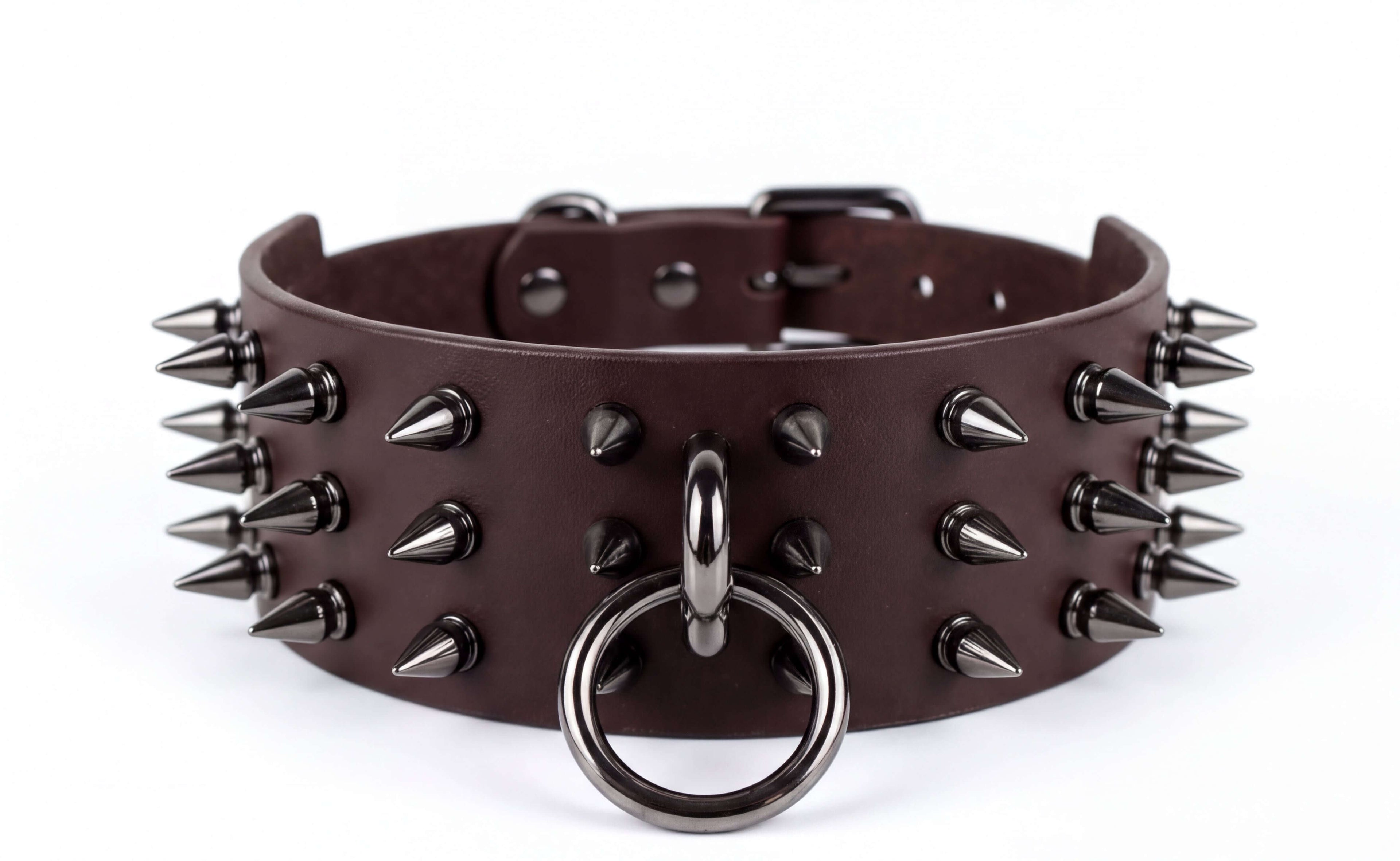 A close-up image of a brown leather choker necklace with spikes protruding from it.