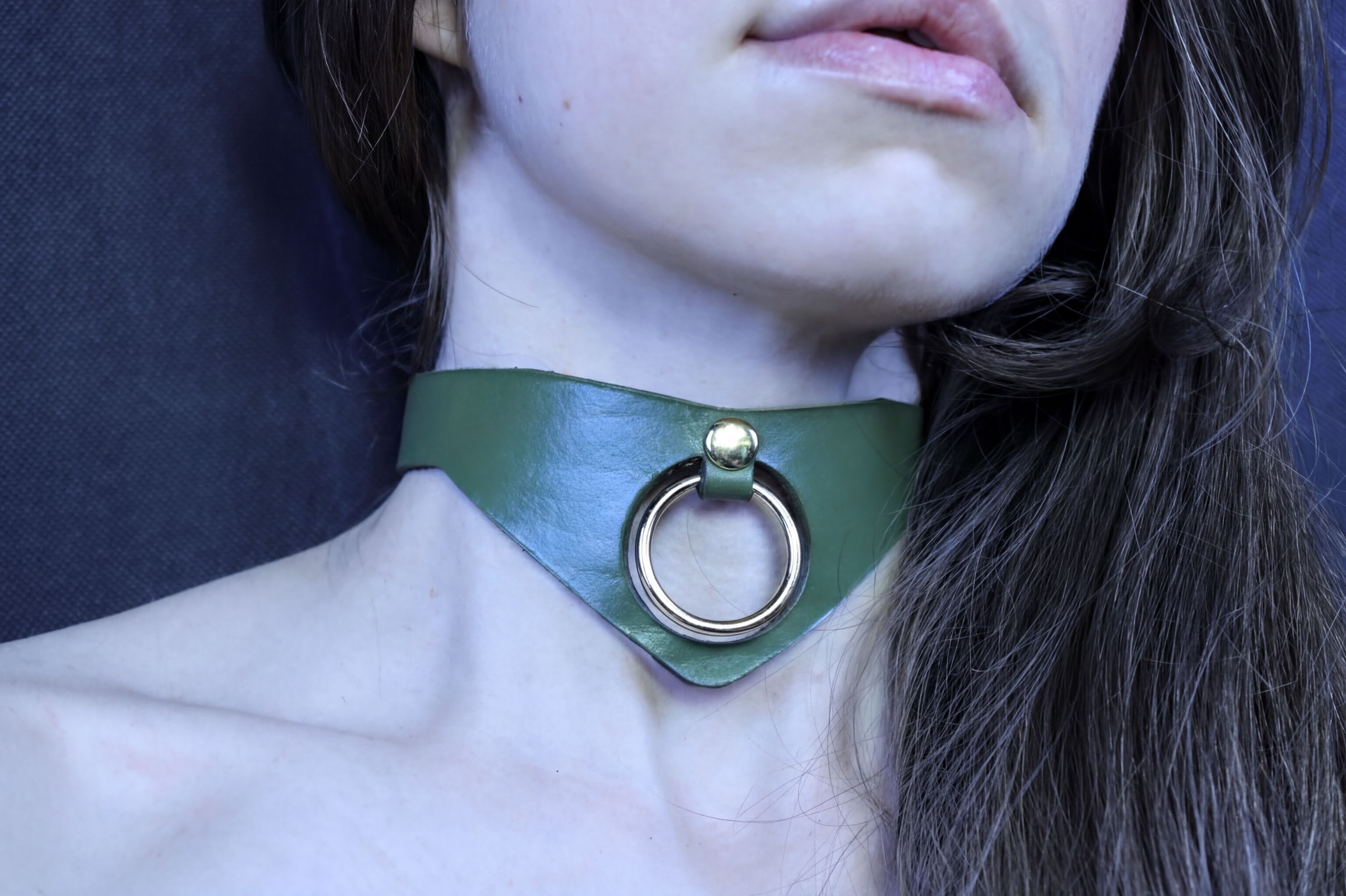 Olive green posture collar with bold O-ring, perfect for submissive jewelry and BDSM style.