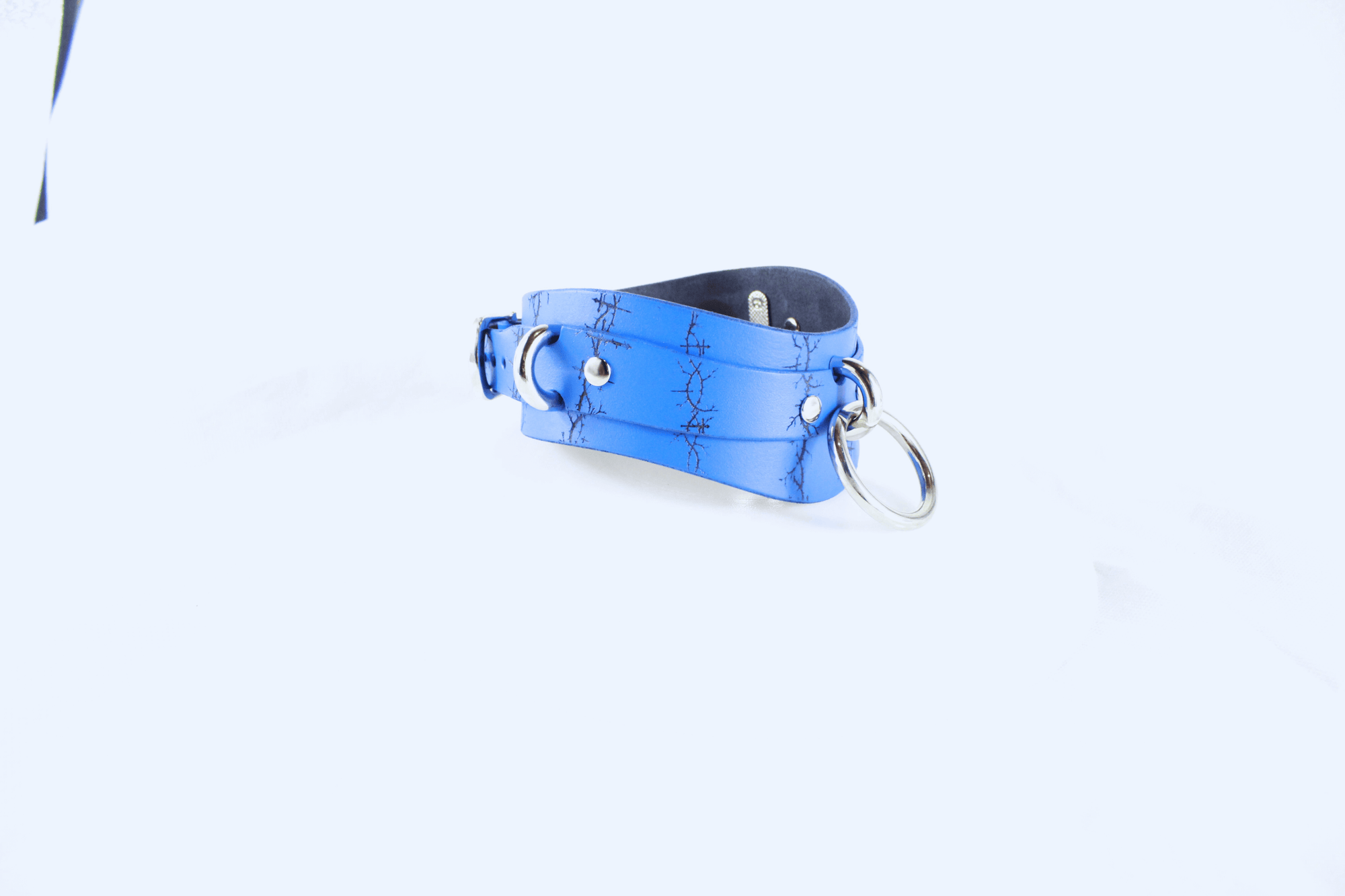 Barbed BDSM Collar in blue leather with rings and etched black barbed design for stylish subservience.