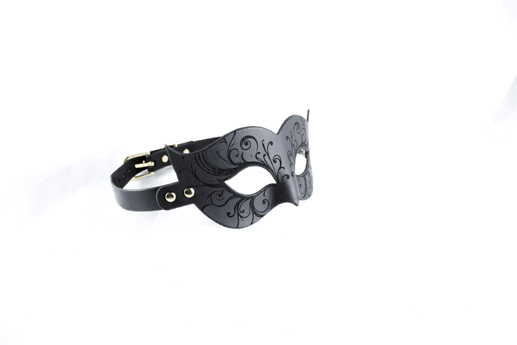 Leather Bondage Mask with Venetian style and black floral details, showcasing intricate engravings and sensual elegance.