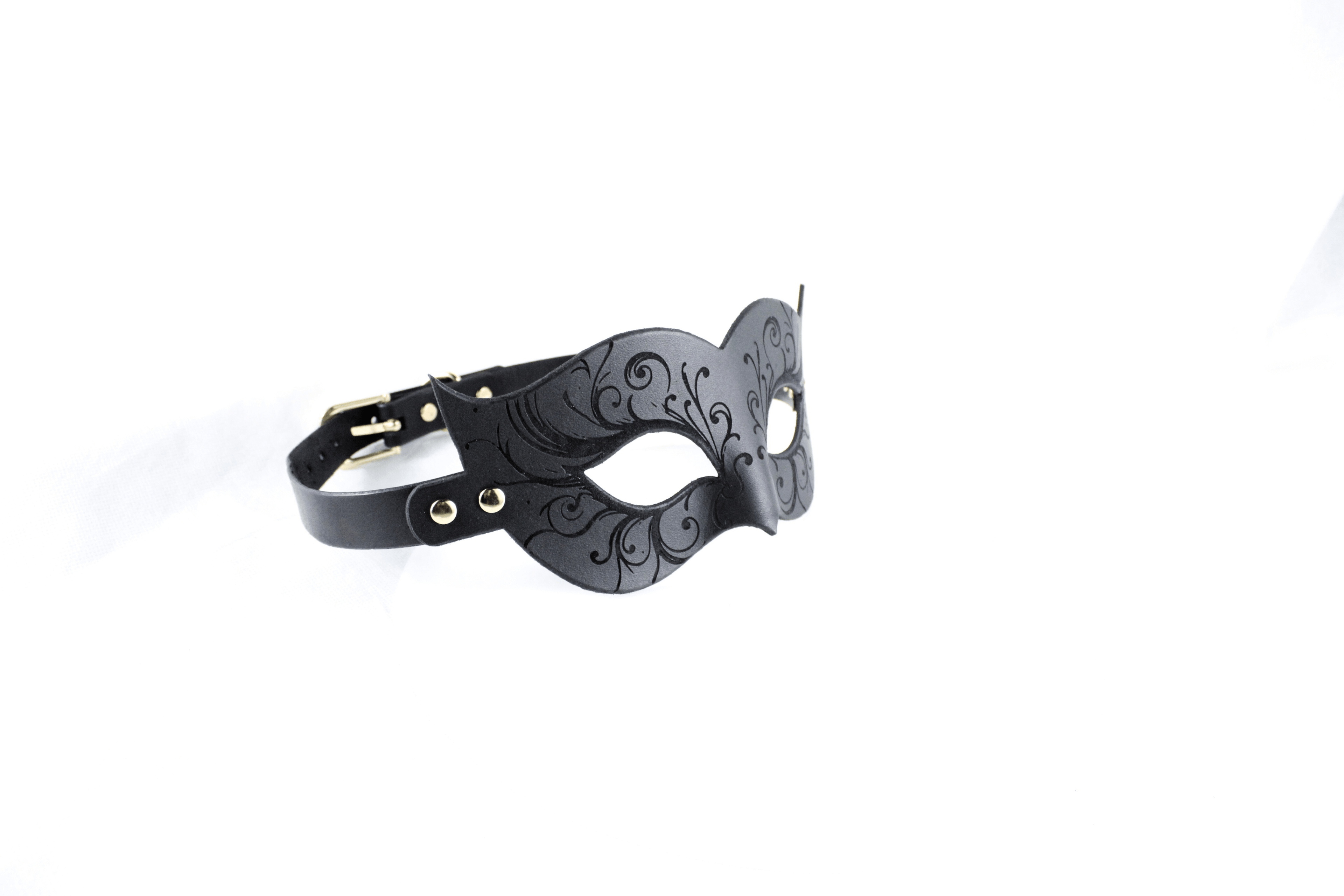 Leather Bondage Mask with Venetian style and black floral details, showcasing intricate engravings and sensual elegance.