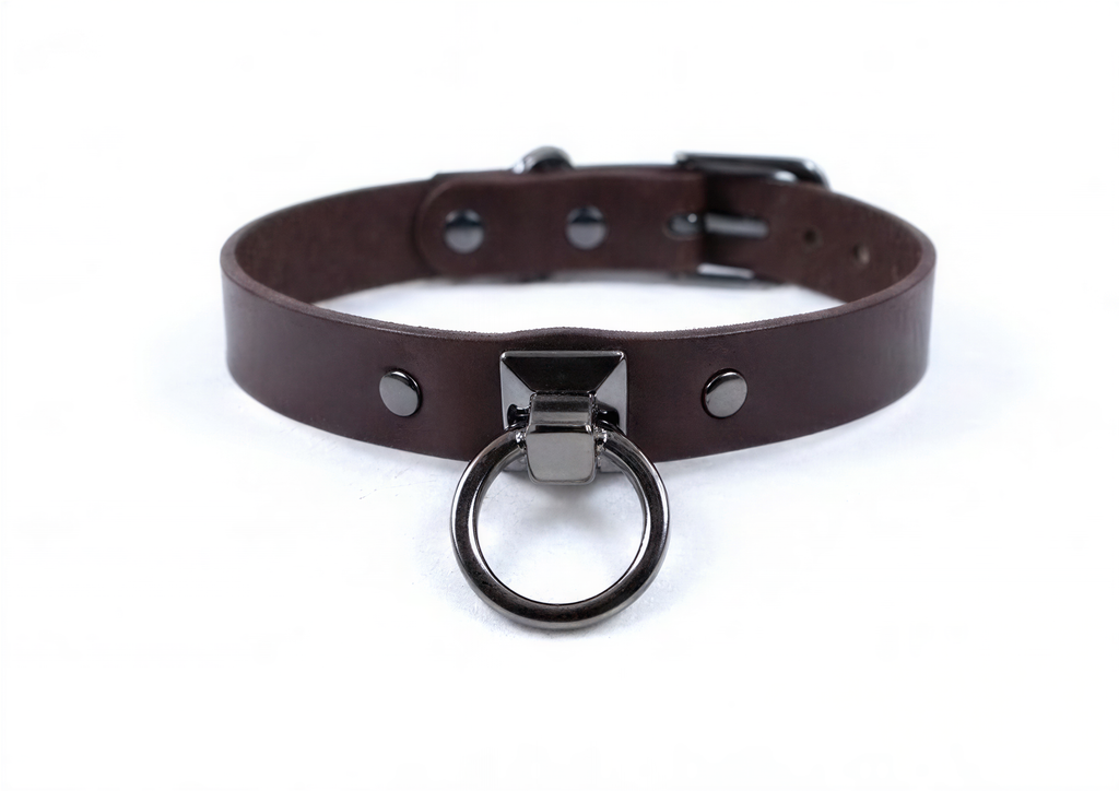 A brown leather choker collar with a metal ring and buckle.