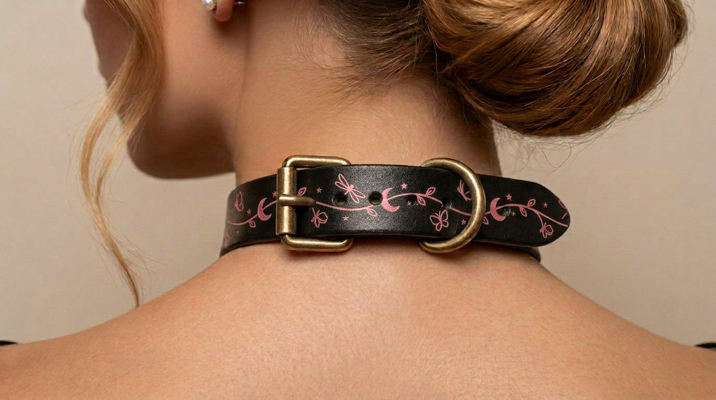 A close-up view of a woman's neck and shoulders, focusing on a black leather choker necklace with a decorative floral pattern.