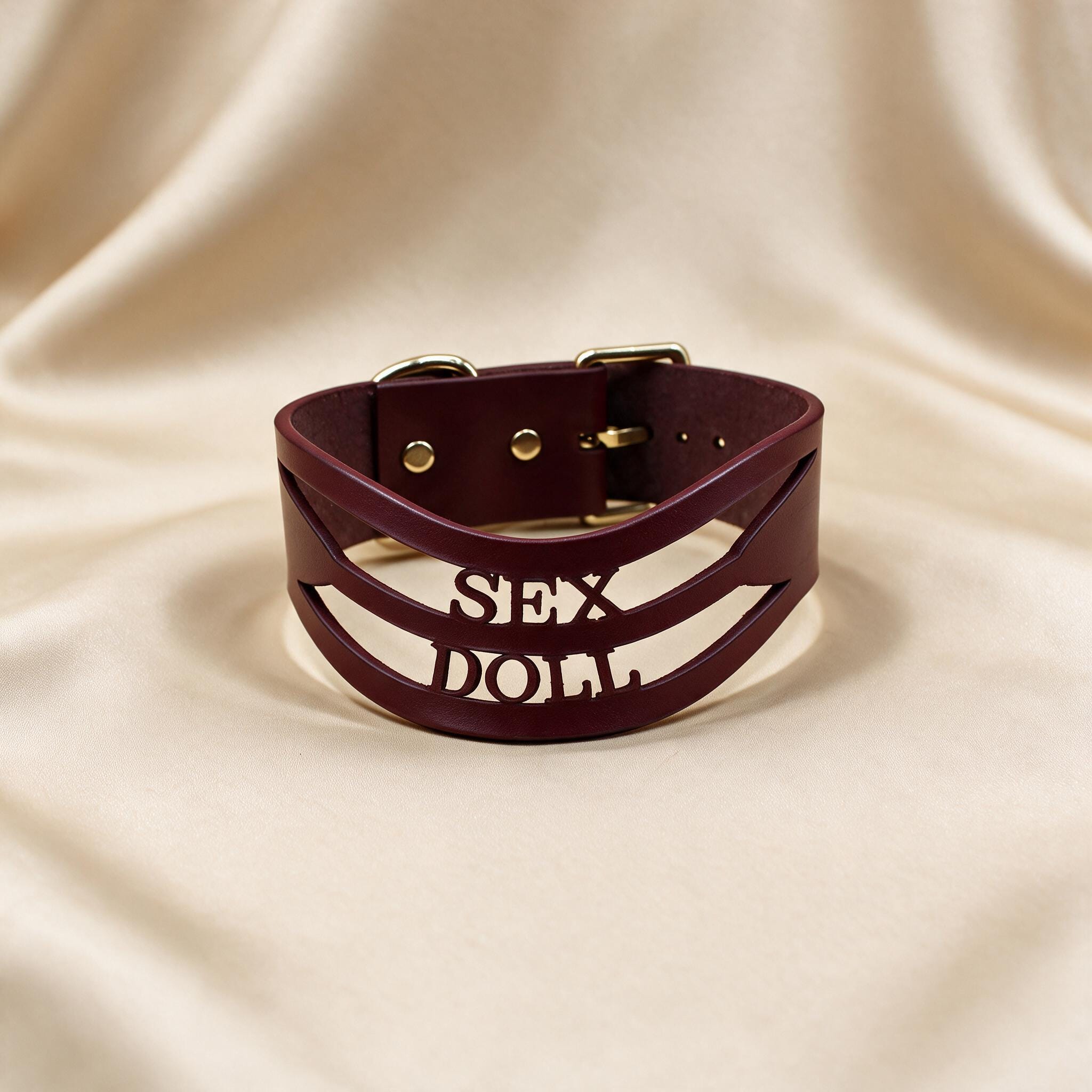 A burgundy leather choker necklace with the word "SEX" printed on it.