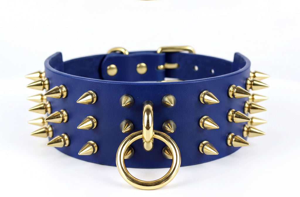 A blue leather choker necklace with gold spikes protruding from it.