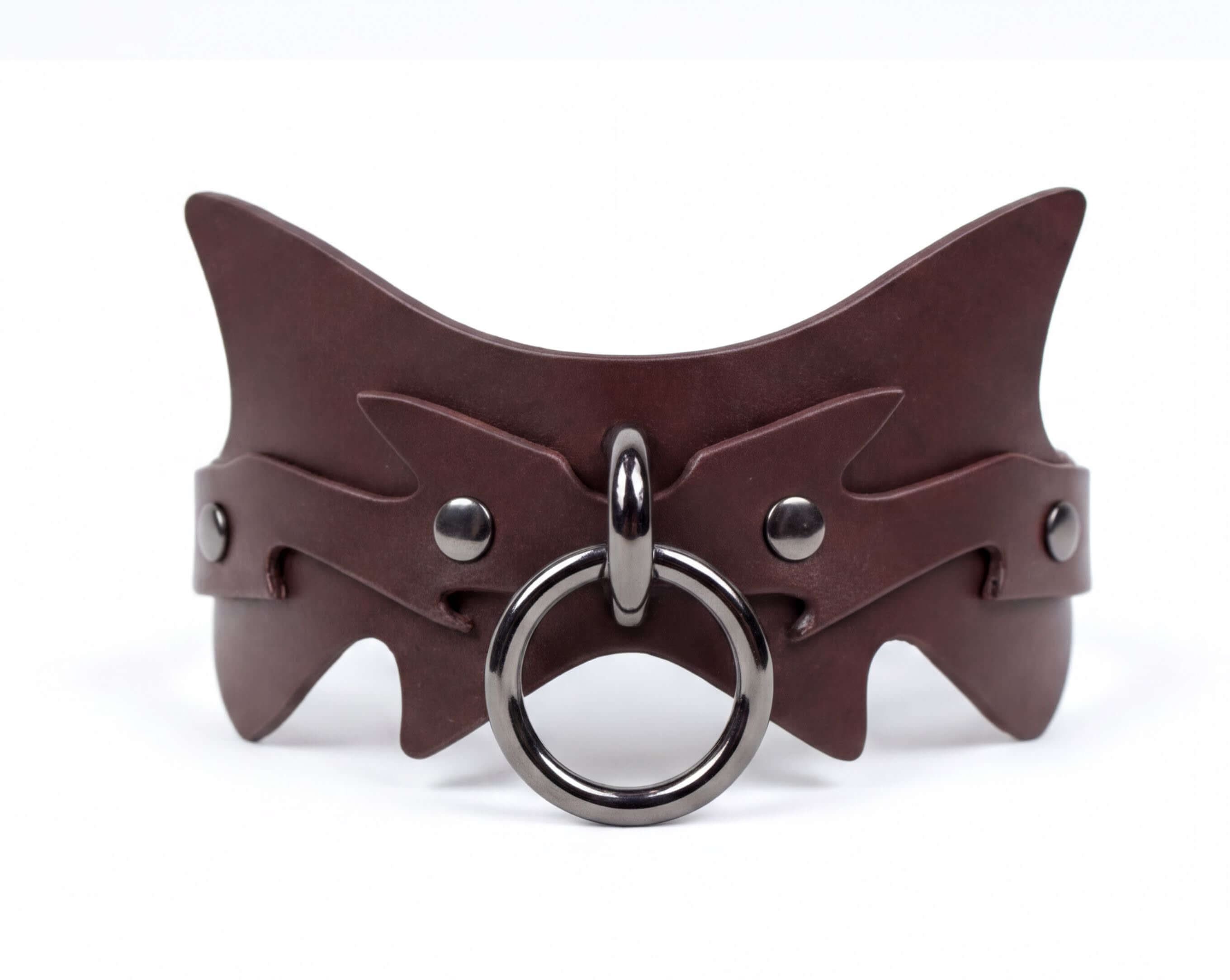 A brown leather choker necklace with a metal ring and a circular metal piece.