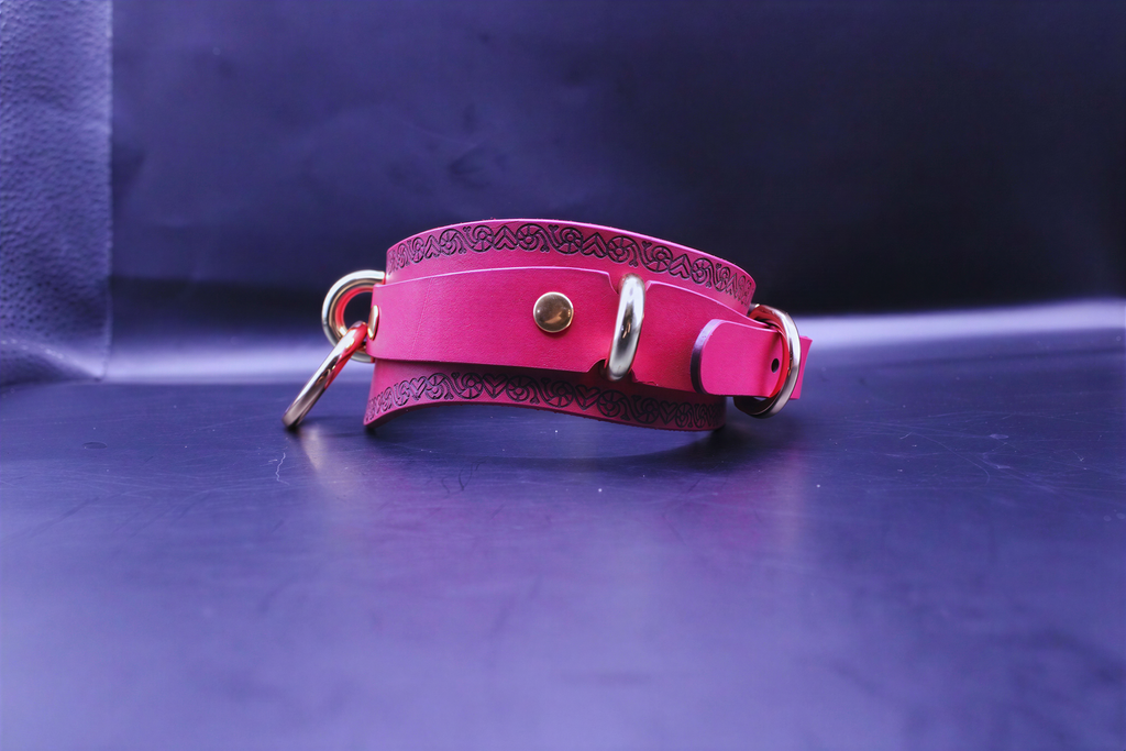 Handcrafted pink bdsm collar with heart design, featuring O-ring for sub collar and bondage gear.