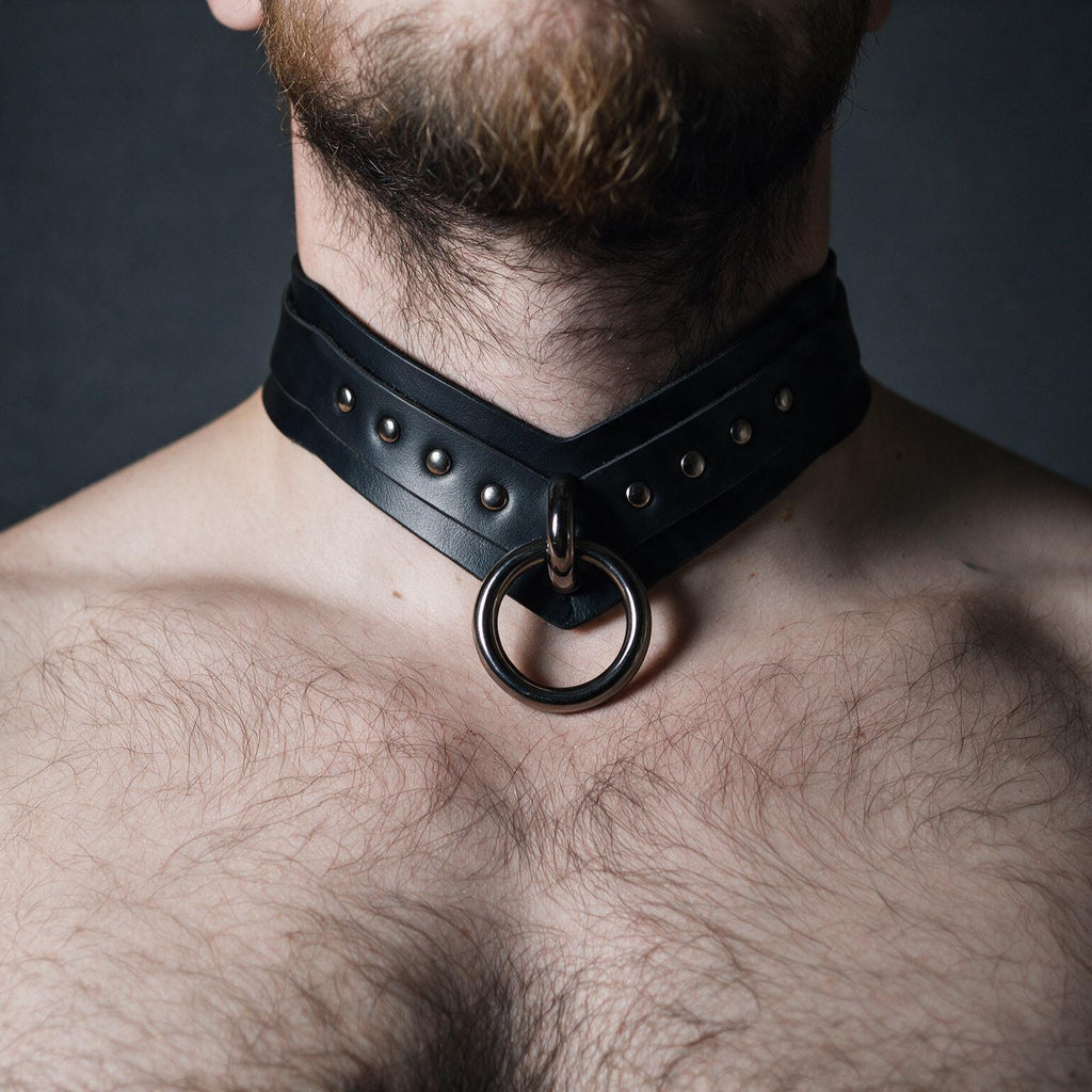 A close-up of a man's neck and chest area wearing a black leather choker necklace with a metal ring.