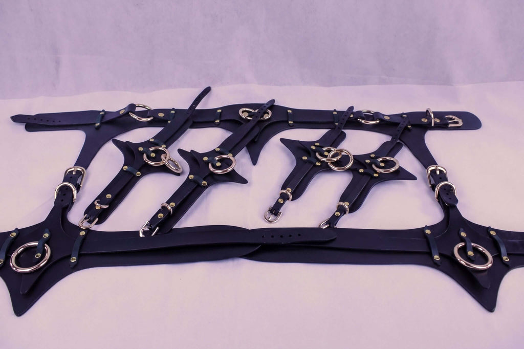 Leather thigh harness and cuffs set for BDSM, featuring high-quality straps and metallic accents for erotic play.