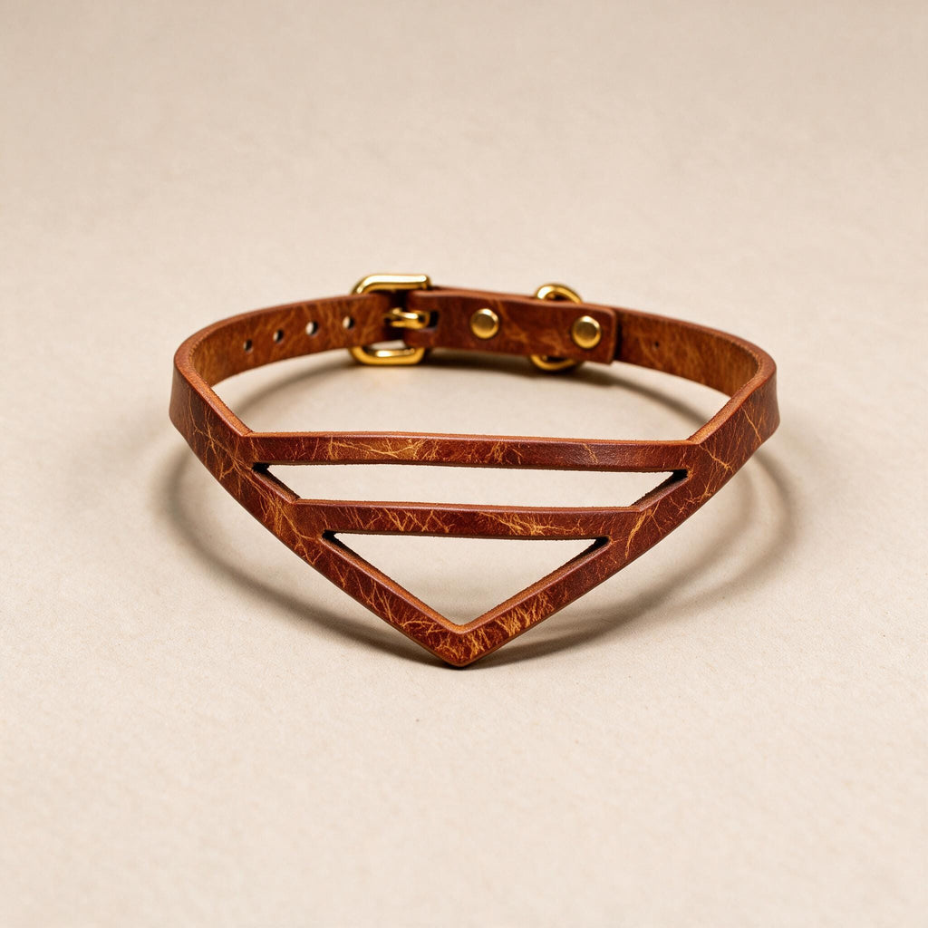A brown leather choker necklace with a geometric design and a gold buckle.
