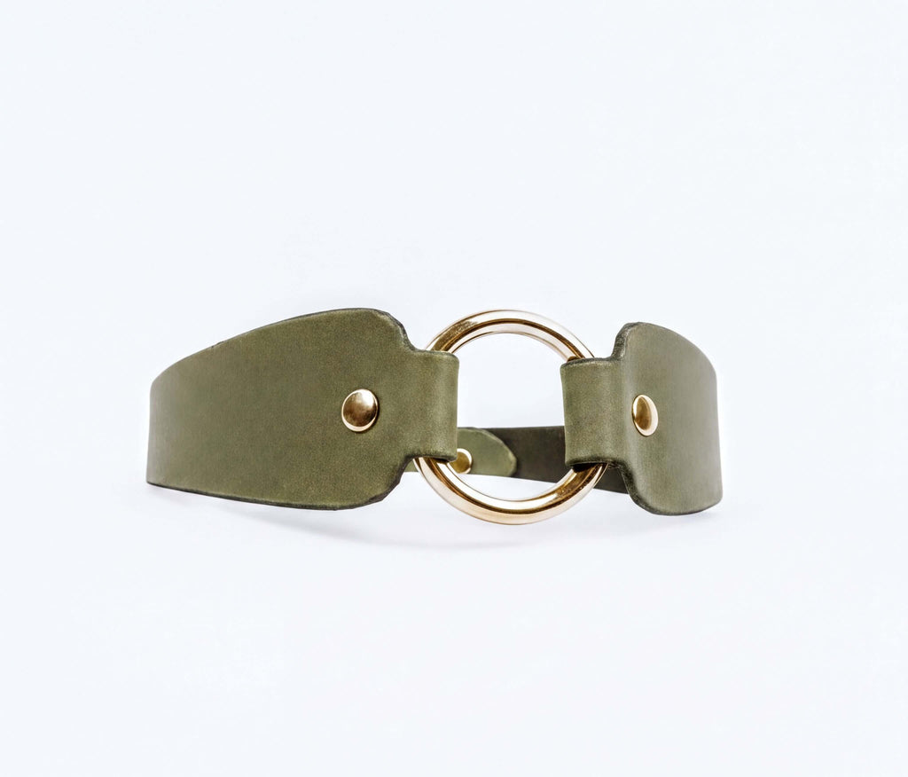 A green leather choker necklace with a gold-colored circular buckle.
