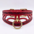 A red leather choker collar with a gold ring and buckle.