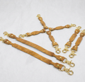 a collection of leather straps with metal clasps, arranged in a way that they appear to be connected or interlocked.