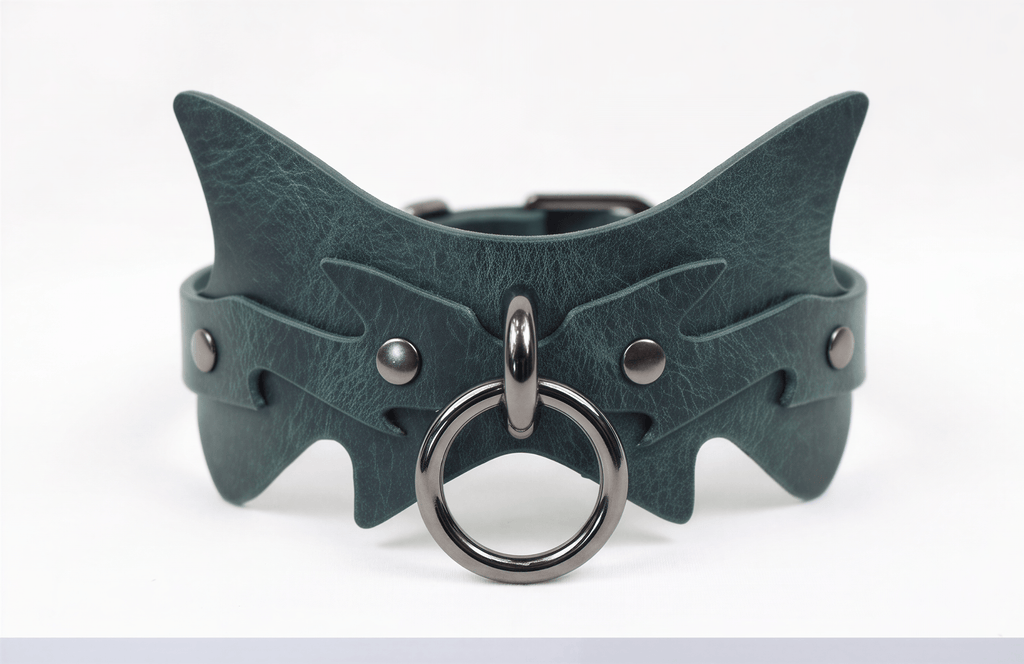 A green leather choker necklace with a metal ring and a metal buckle.